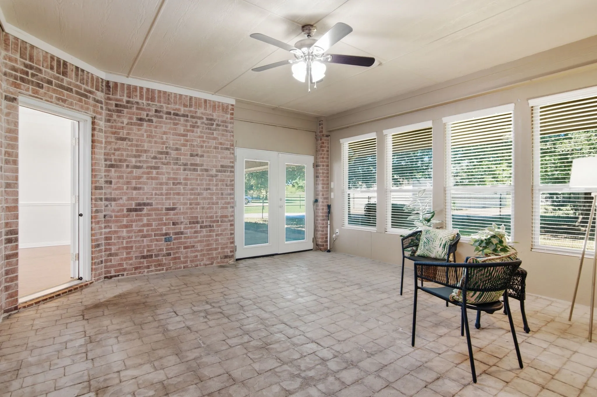 Enclosed sunroom18 x 16, with heat & air conditioning!  Perfect for all year relaxing or outdoor dining! Brick flooring!