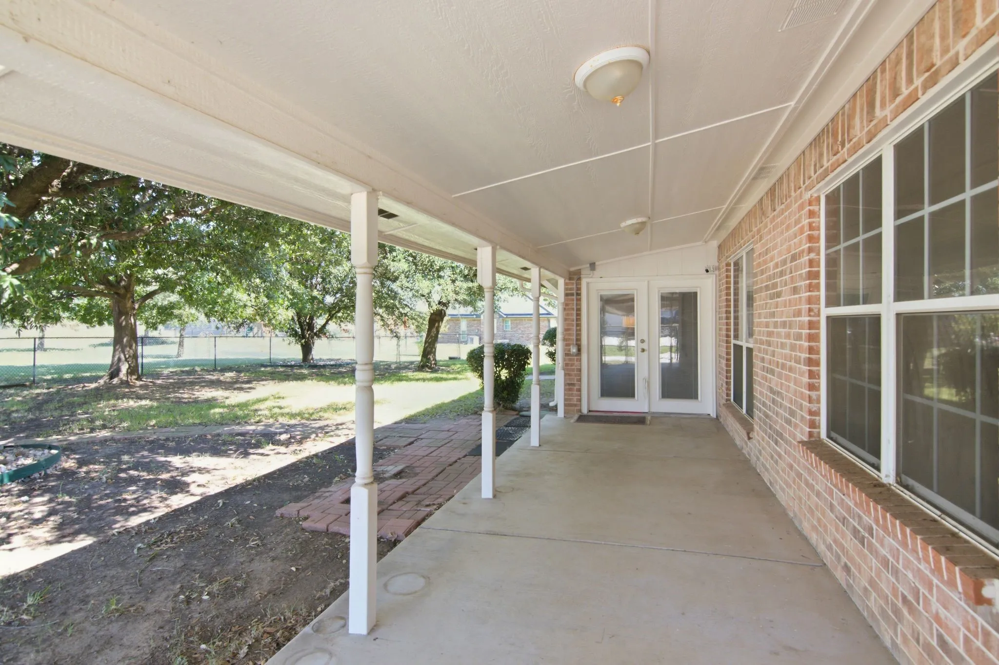 Covered Patio with fenced in area for children & pets to play!  Mature trees for a shady back yard!
