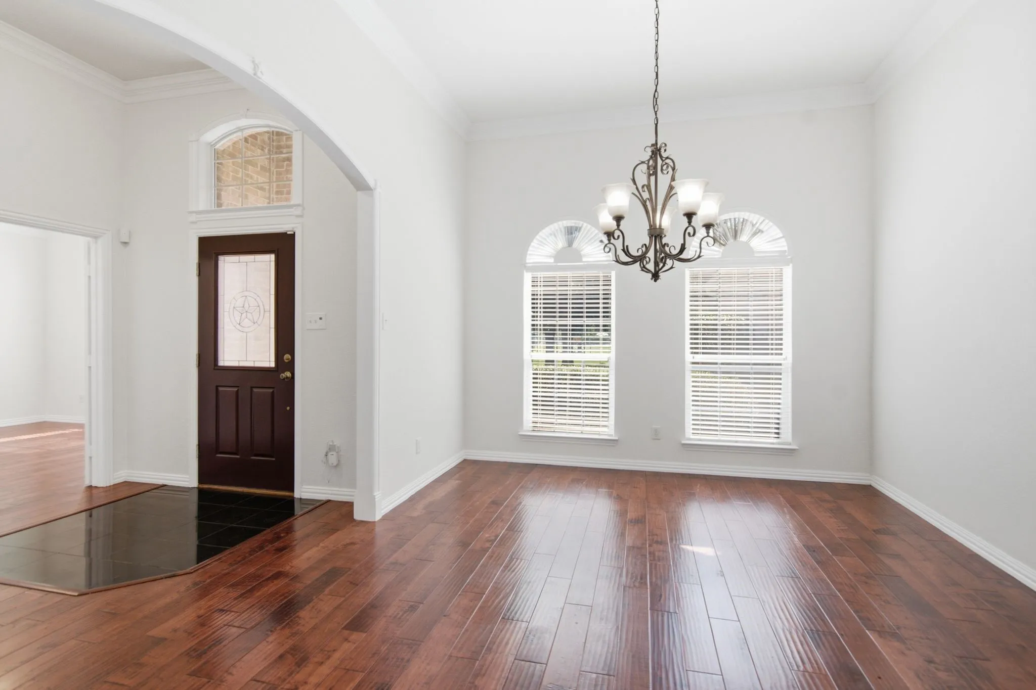 Fabulous formal dining with tall ceilings, arch opening, rich wood floors, light & bright!