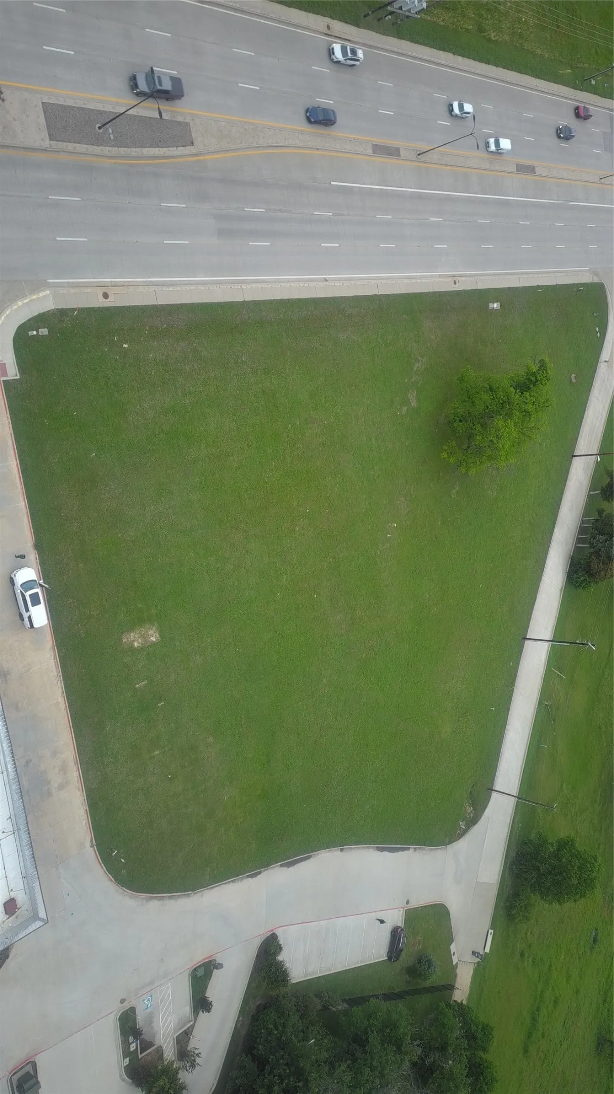 Expansive corner lot featuring a large green space
