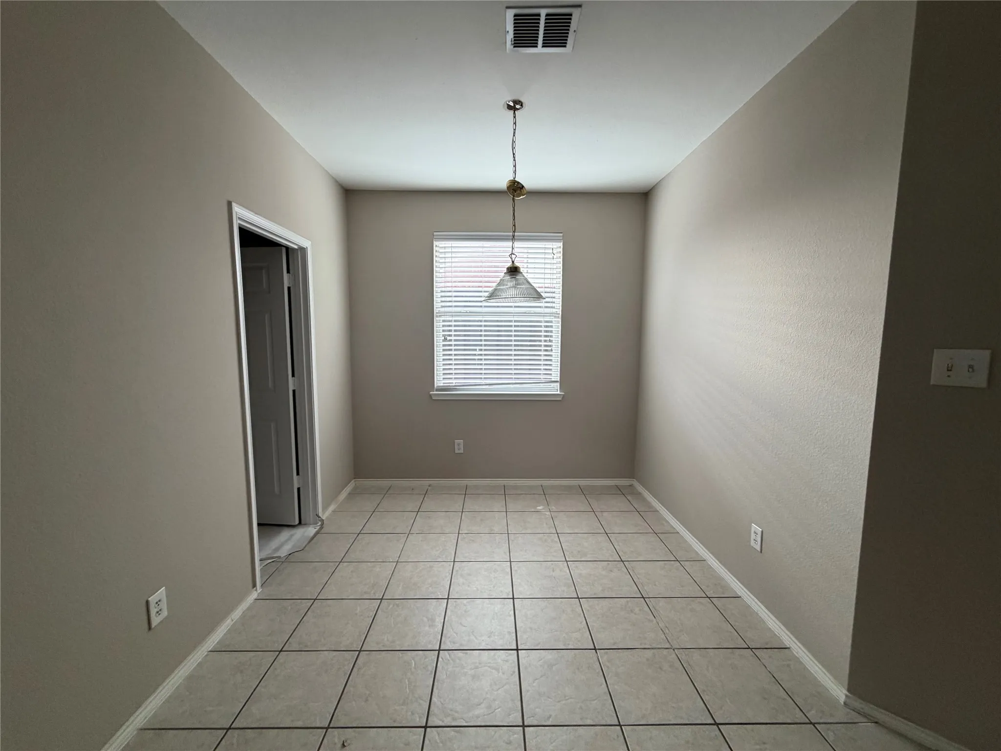 Neutral-toned walls complement the tile flooring