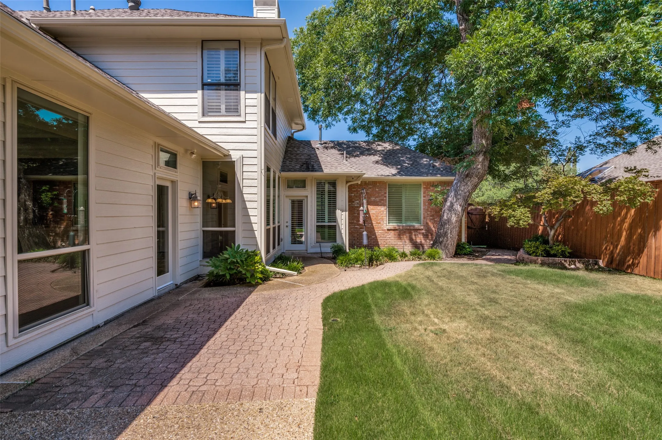 Nice walkway along the back of the house with landscaping.