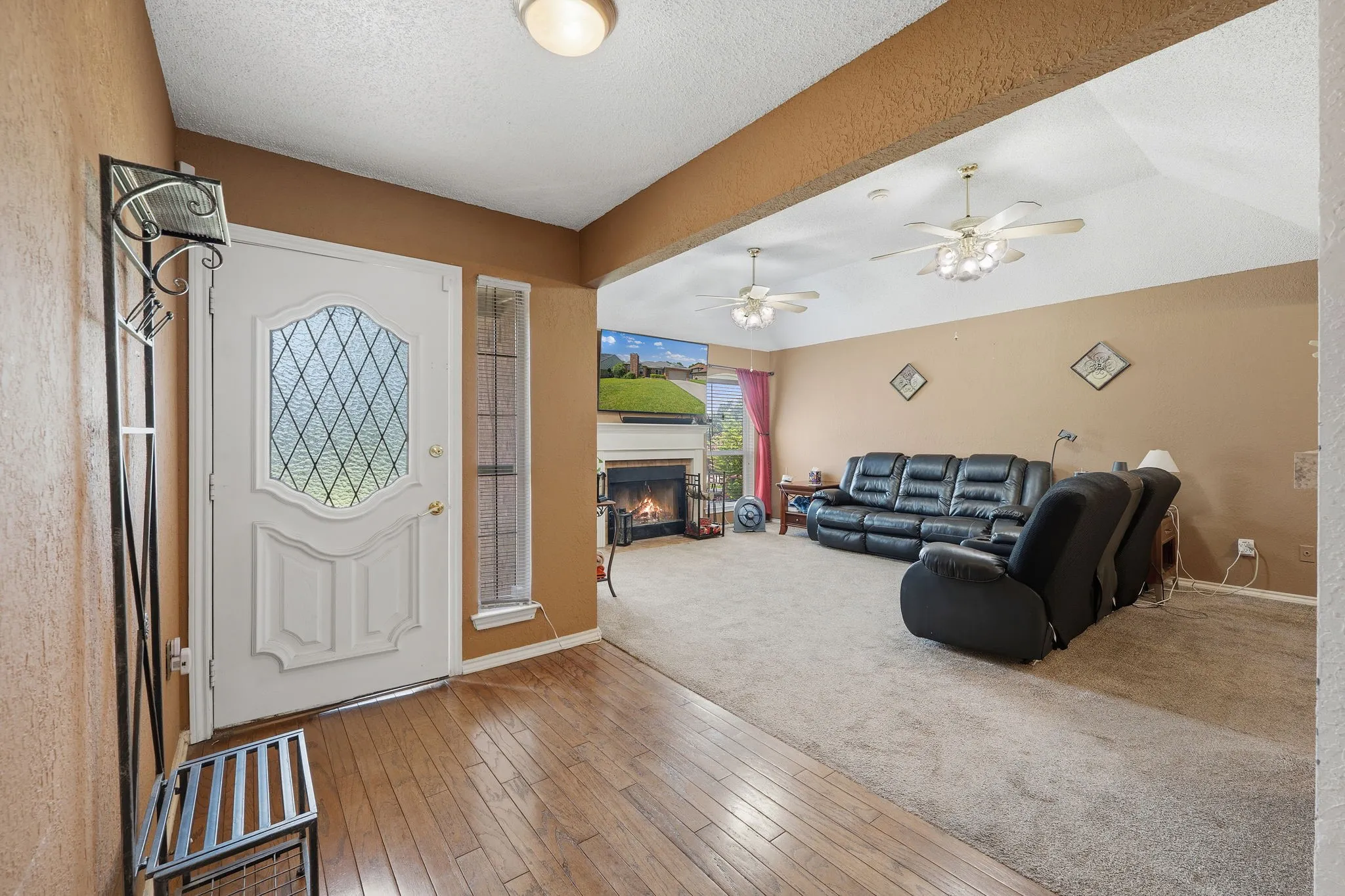 Foyer entryway featuring wood-finish flooring and a decorative glass front door with an accompanying sidelight