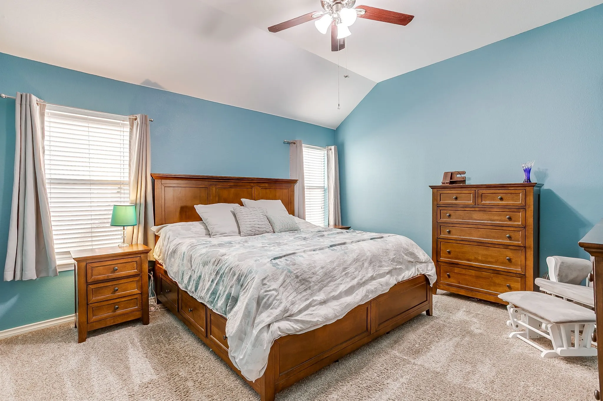 Spacious primary bedroom with vaulted ceiling.