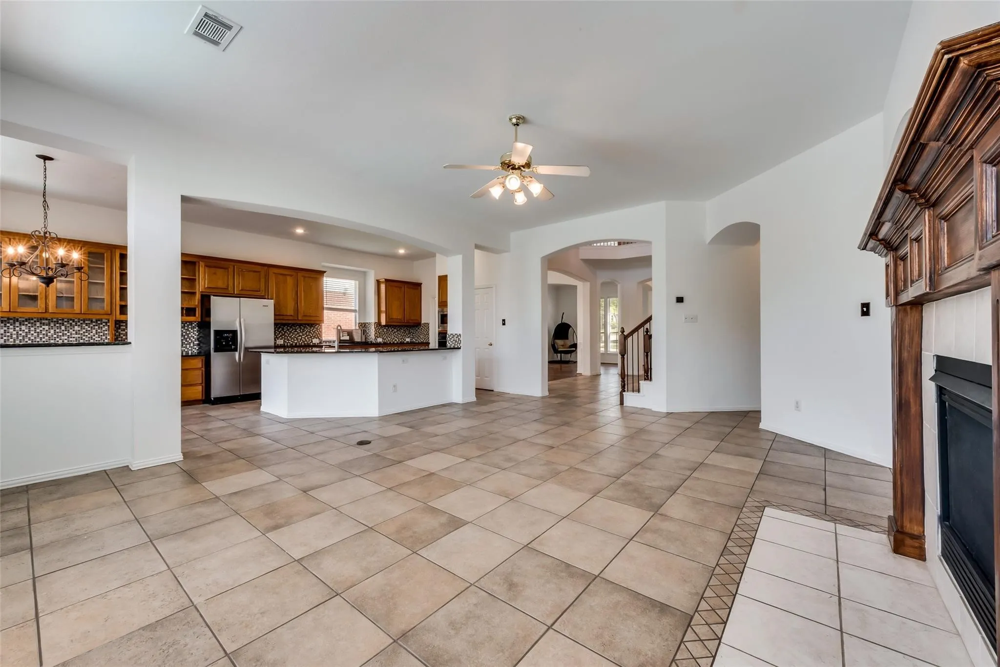 Expansive tile flooring extending through the living area and into the kitchen