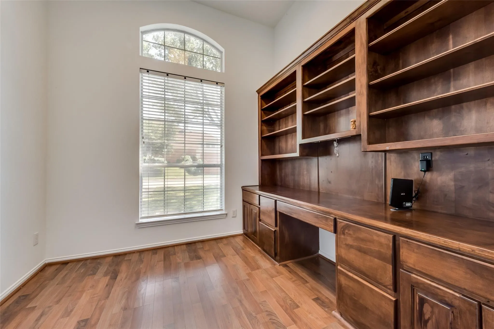 Built-in wood cabinetry with integrated shelving and desk space