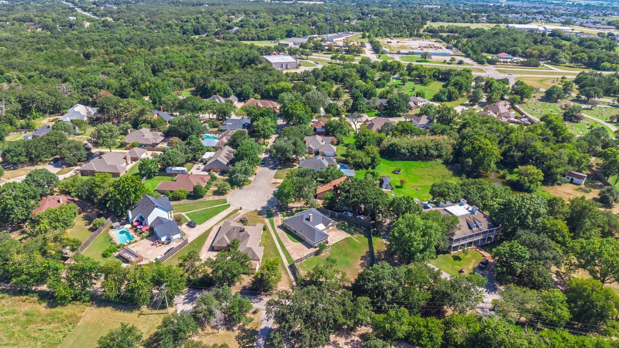 Aerial perspective showcasing a residential community with mature tree coverage