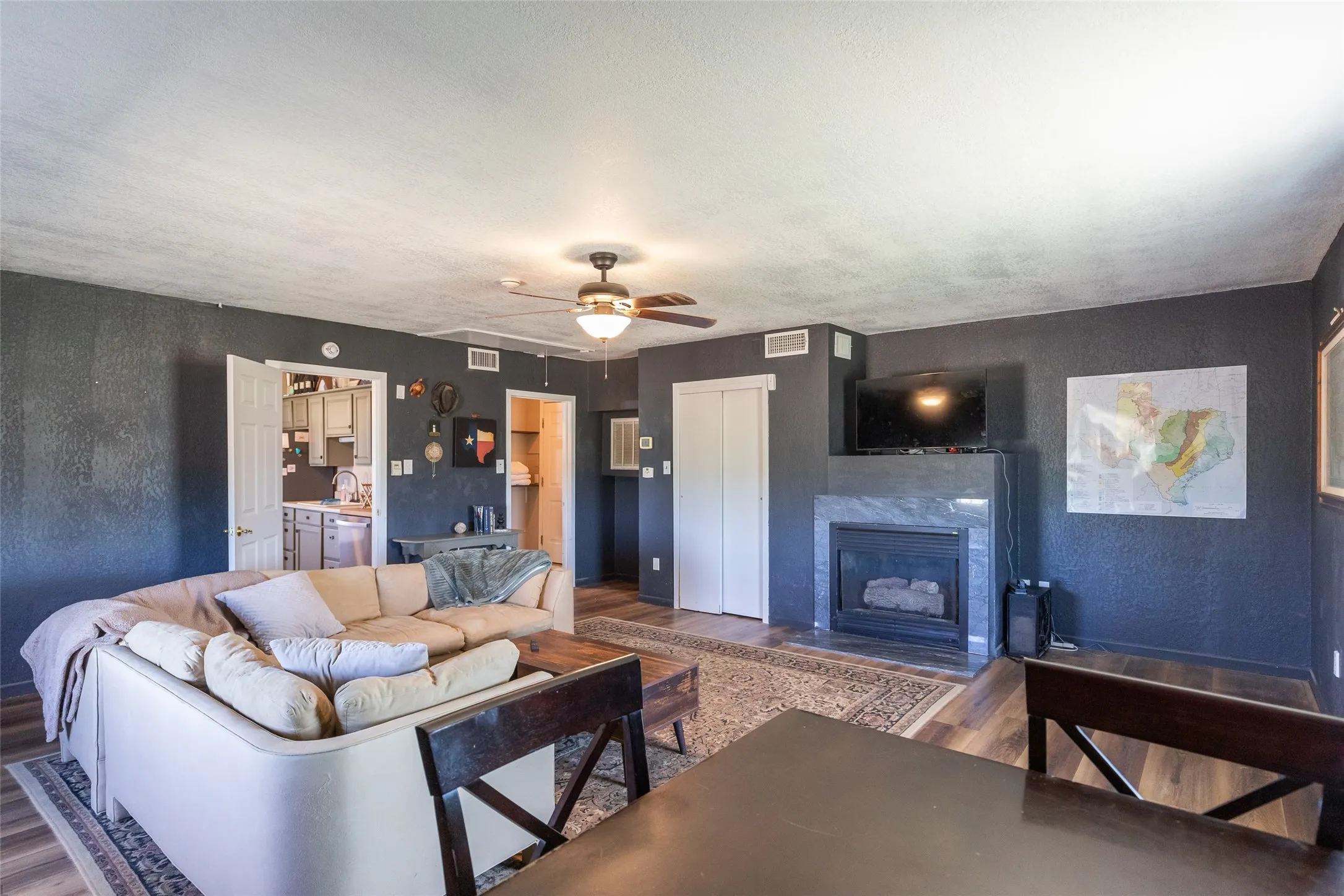 Living area featuring wood-finish flooring and dark-painted walls