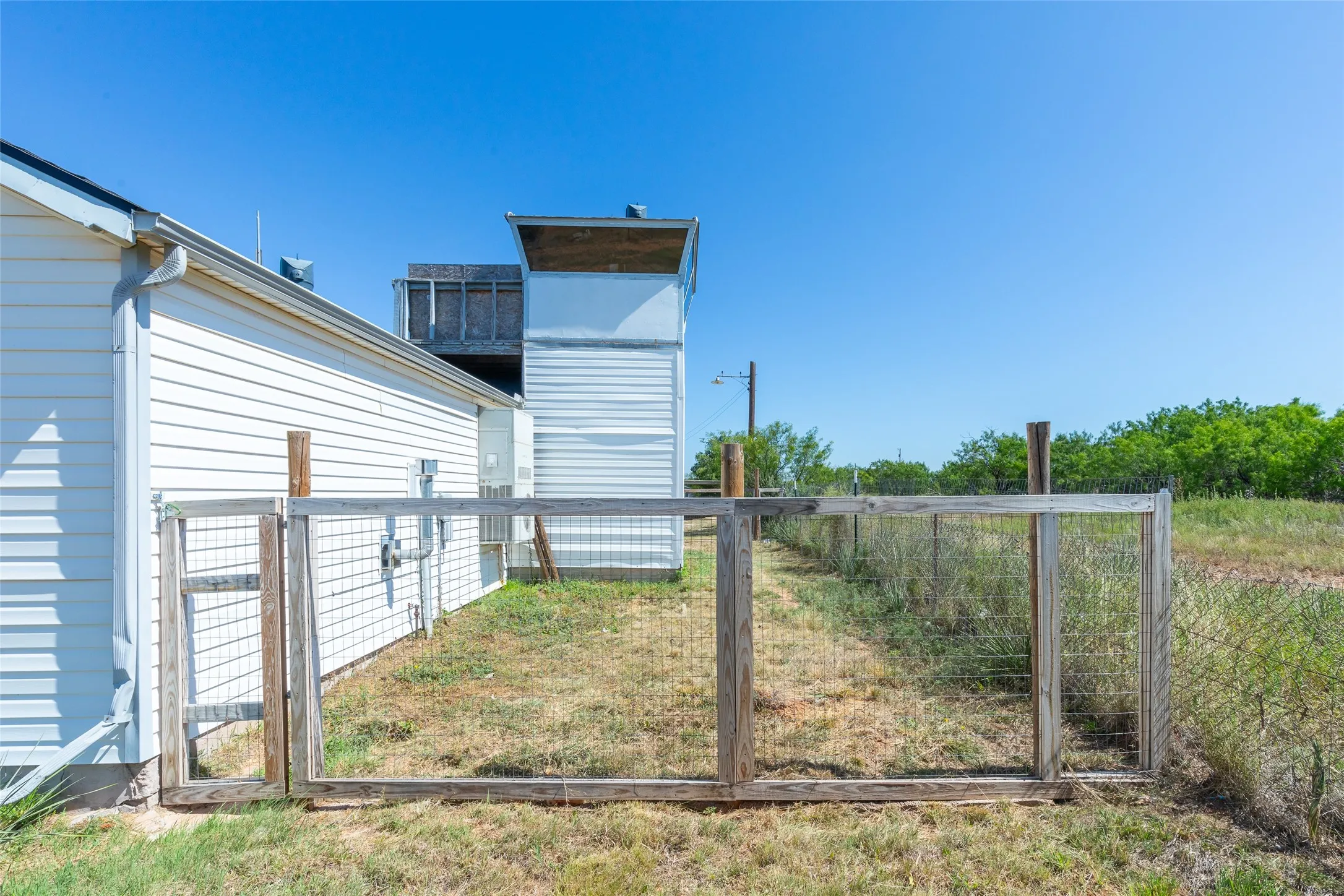 View of side of home and fenced yard