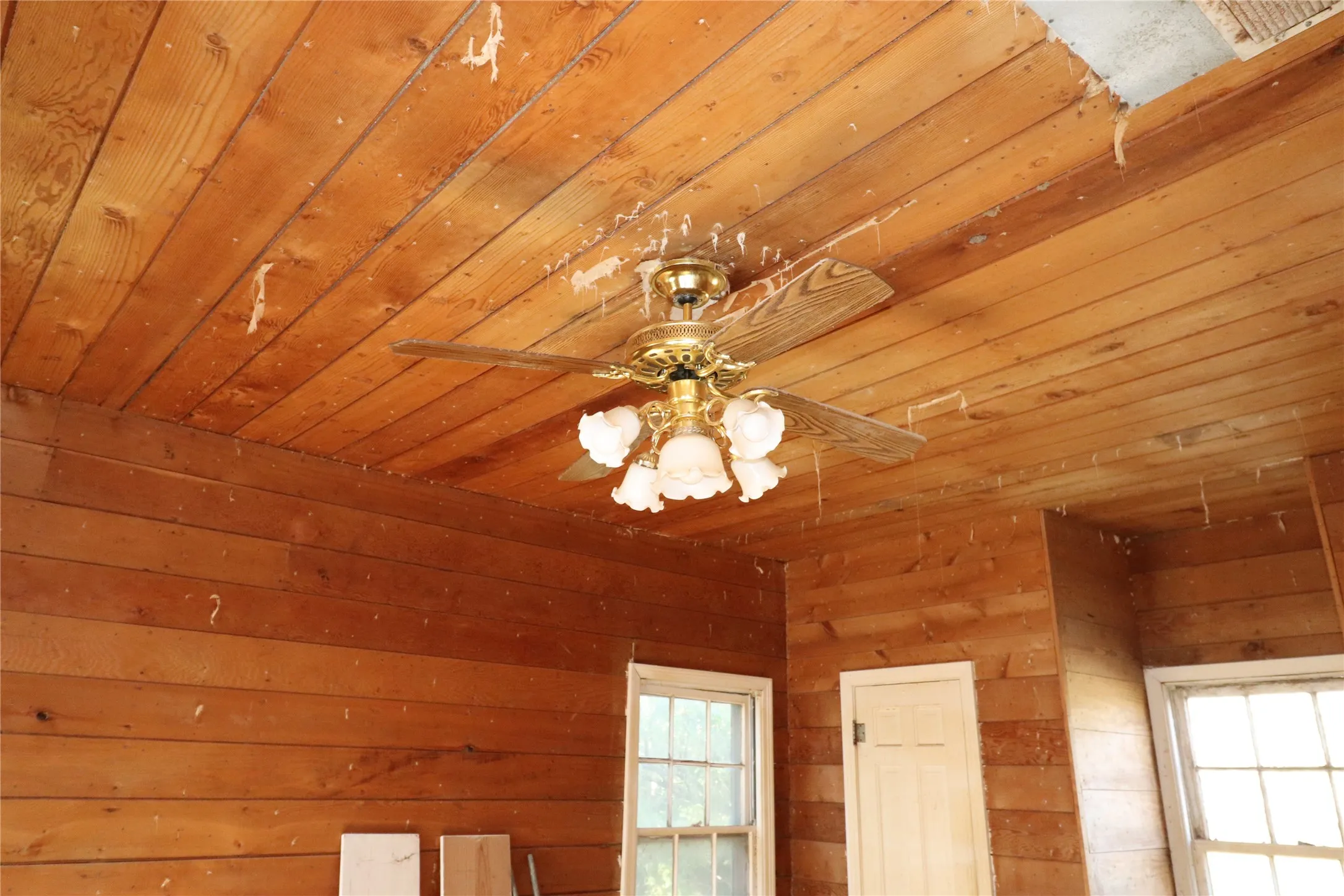 Room featuring wood plank walls and a wood plank ceiling