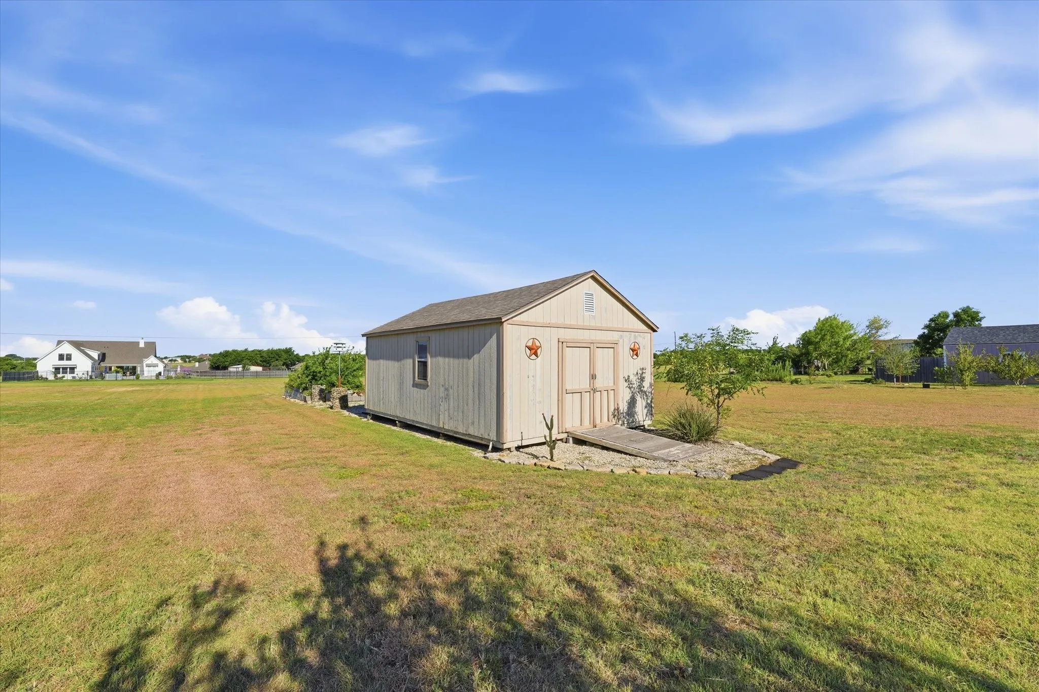 Detached storage shed with wood siding and a gabled roof