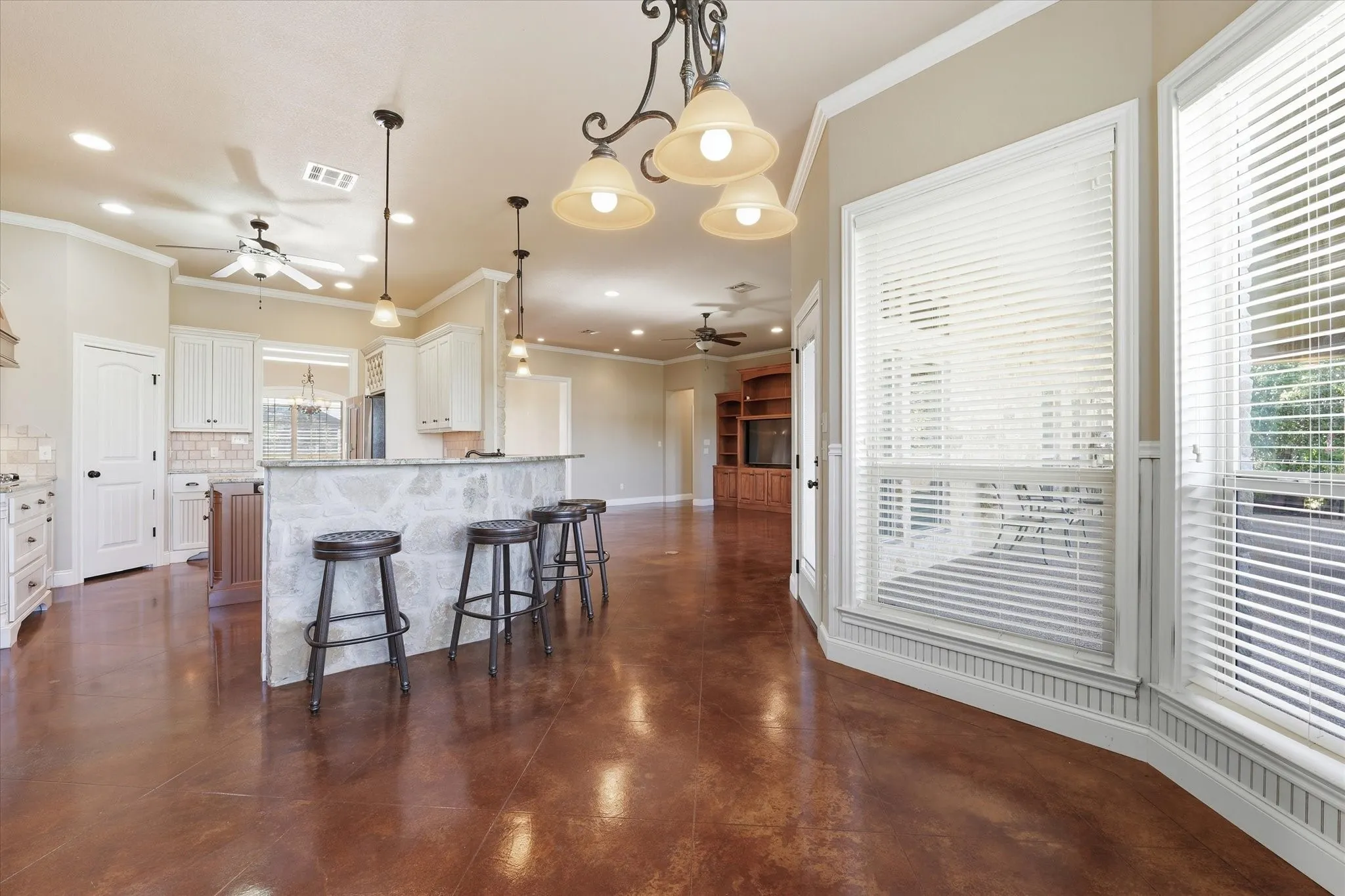 Open-concept living area with polished concrete flooring