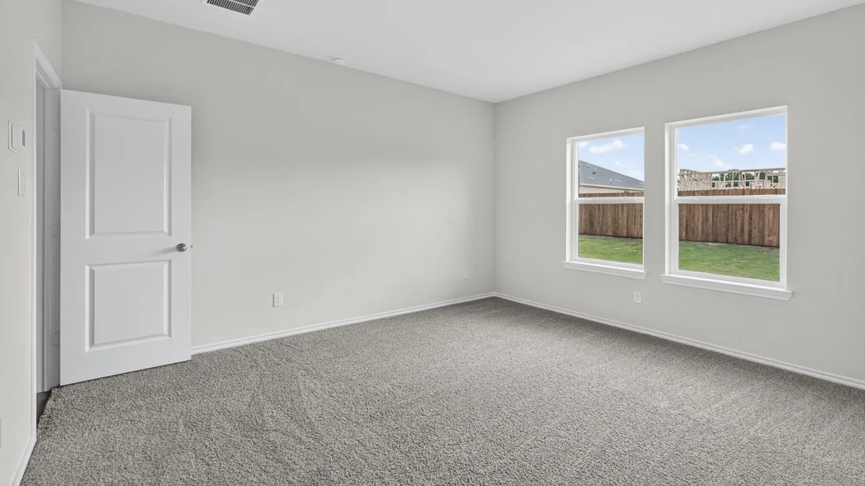 Carpeted room featuring light gray walls, white trim, and two paneled interior doors