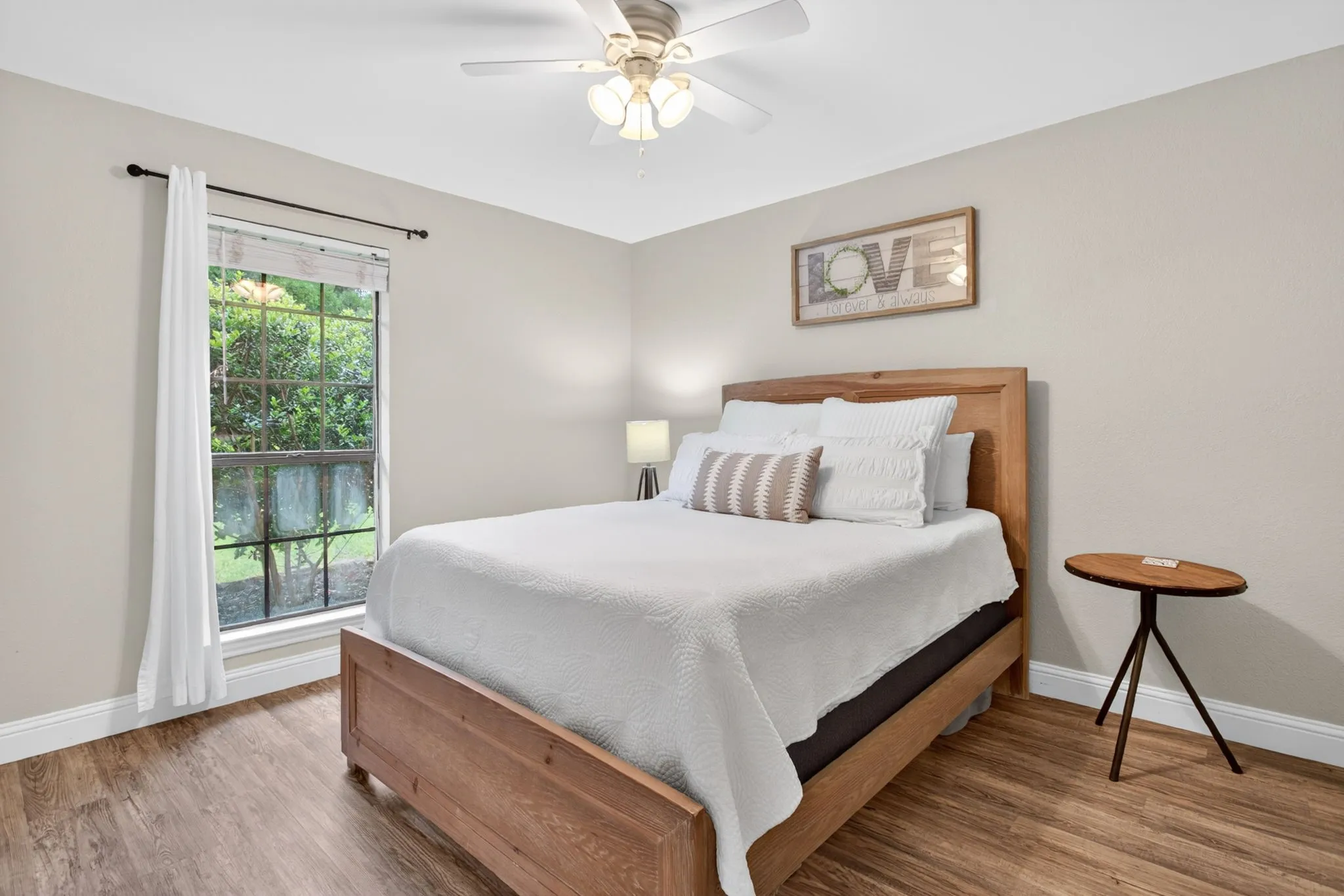 Neutral wall paint with crown molding and wood-finish flooring