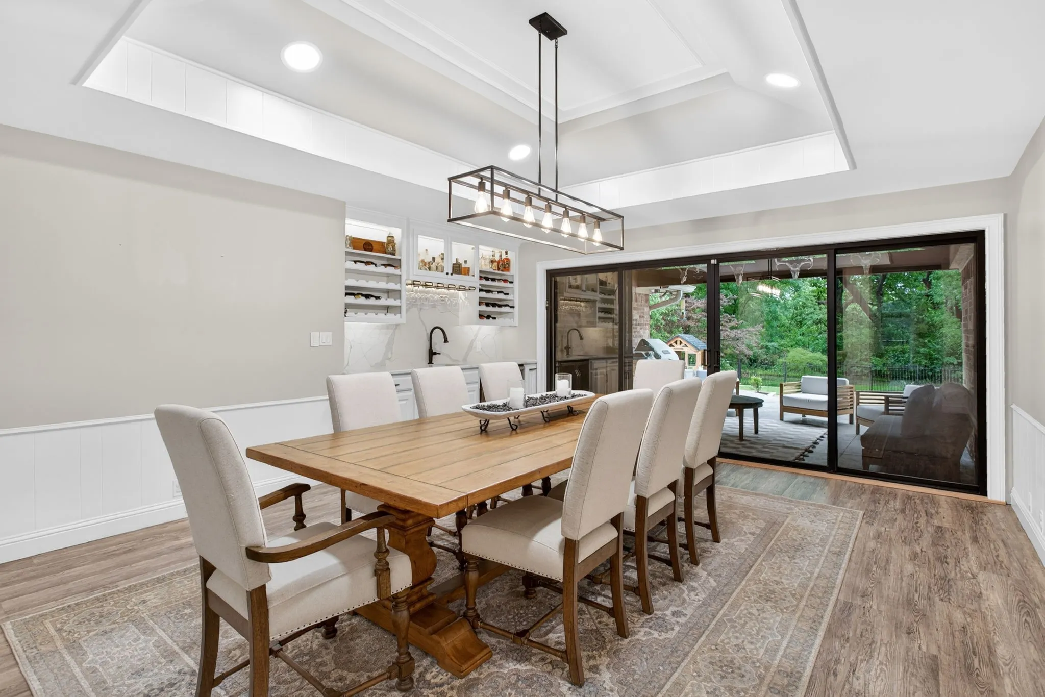 Dining area featuring wood-finish flooring, wainscoting, and a coffered ceiling with recessed lighting