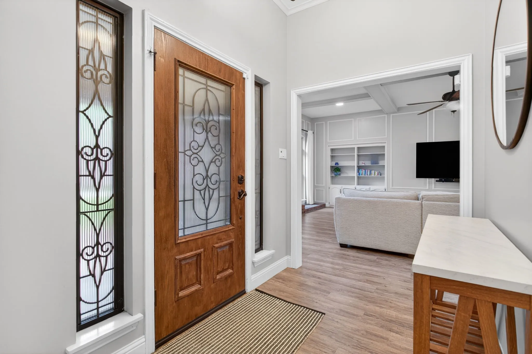 Entryway featuring a wood-finish door with decorative glass inserts and side windows