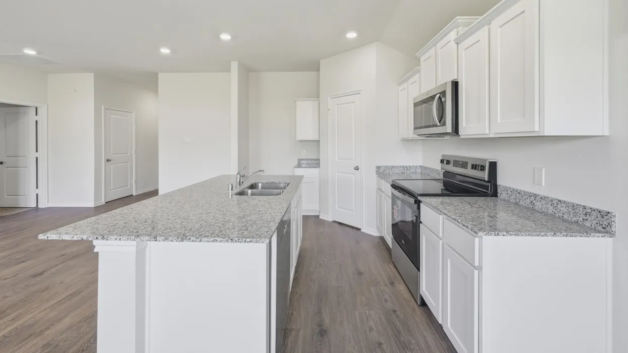 Kitchen featuring an expansive island with dual sinks and ample counter space