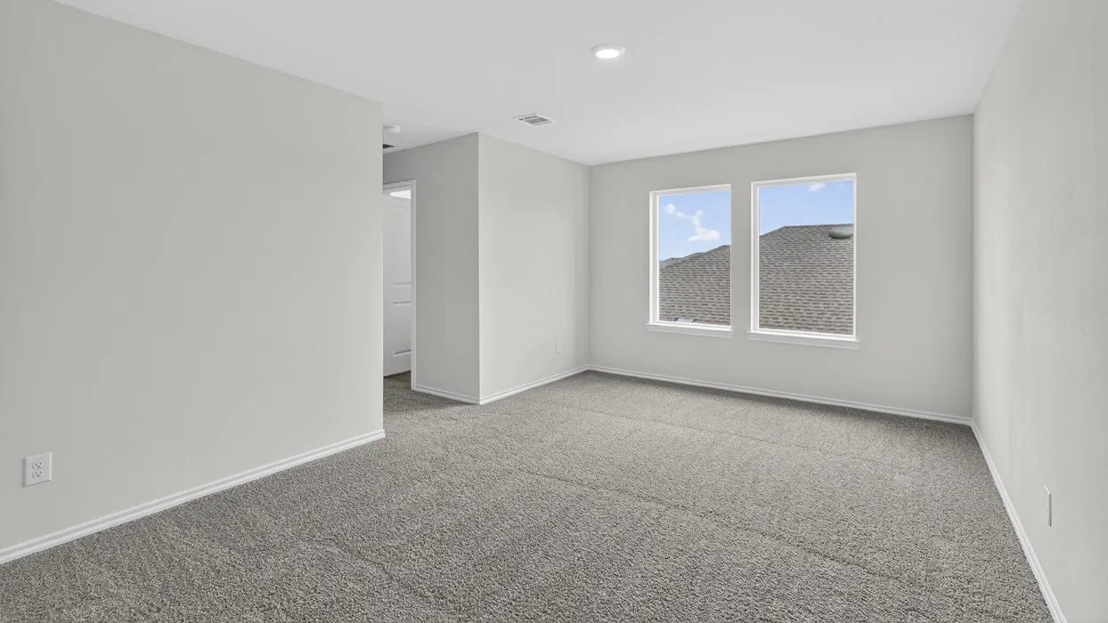Spacious room with plush gray carpeting, neutral wall color, and two large windows providing natural light