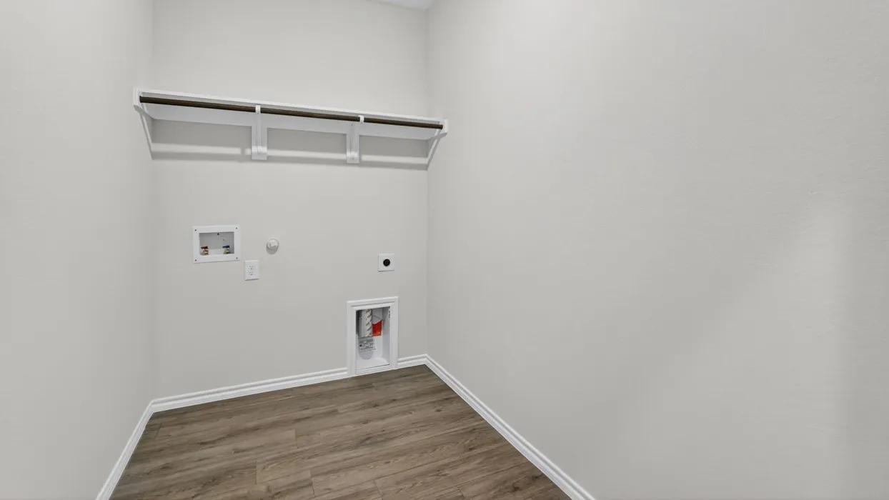 Dedicated utility space featuring wood-finish flooring and light gray walls