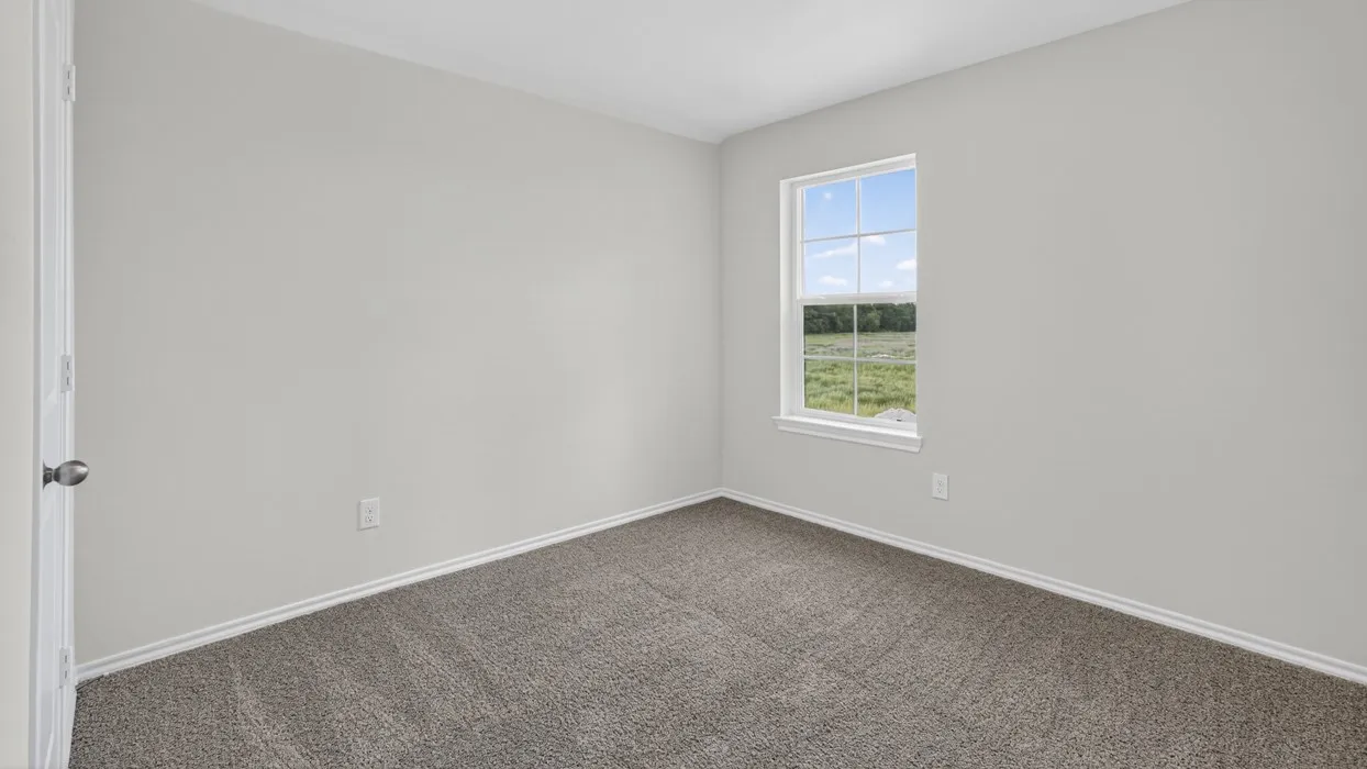 Room featuring light gray walls, gray carpet, white trim, and a window with a white frame