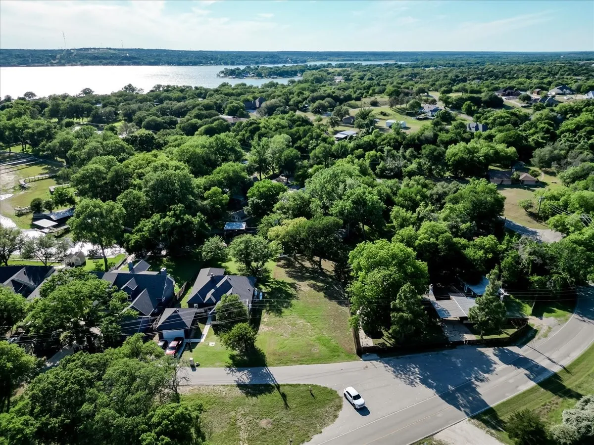 Expansive wooded landscape with a prominent body of water in the distance