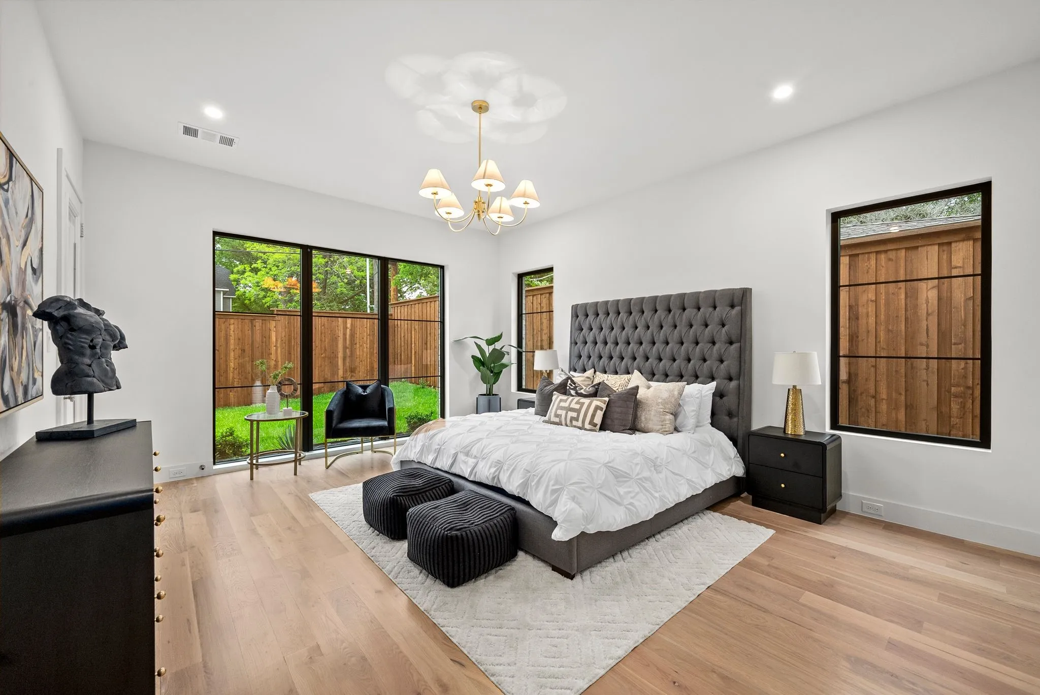 Spacious bedroom with light wood-finish flooring