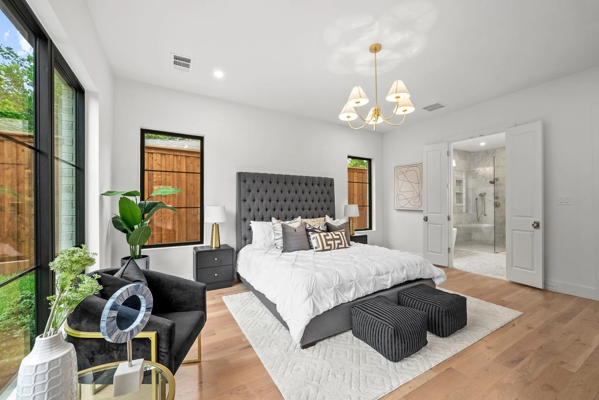 Light wood-finish flooring with a white area rug