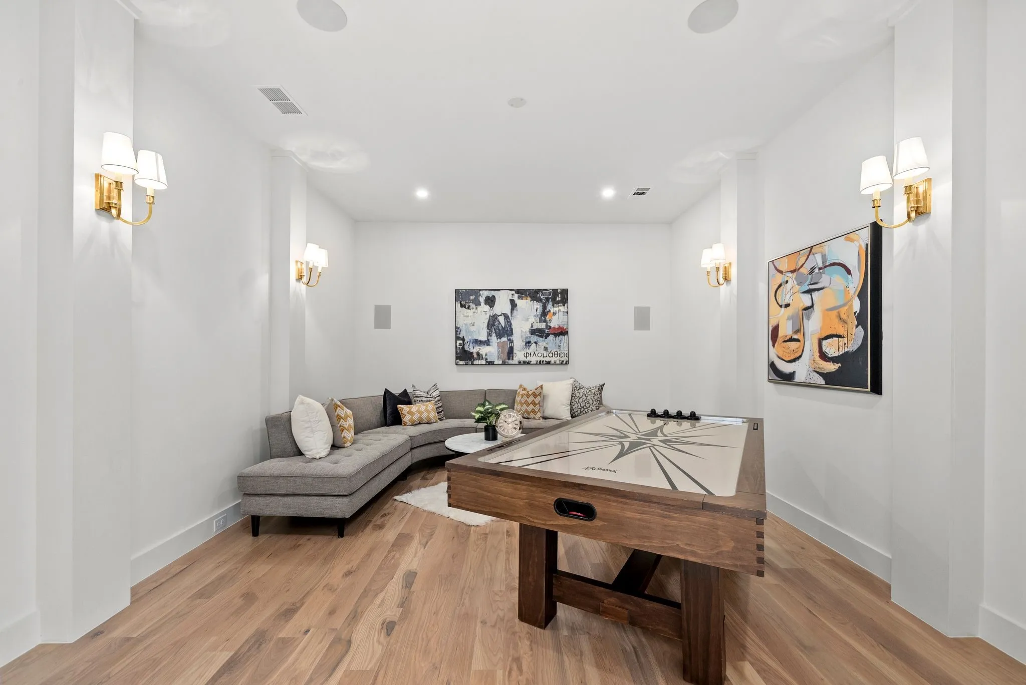 Spacious room featuring wood-finish flooring, recessed lighting, and white walls