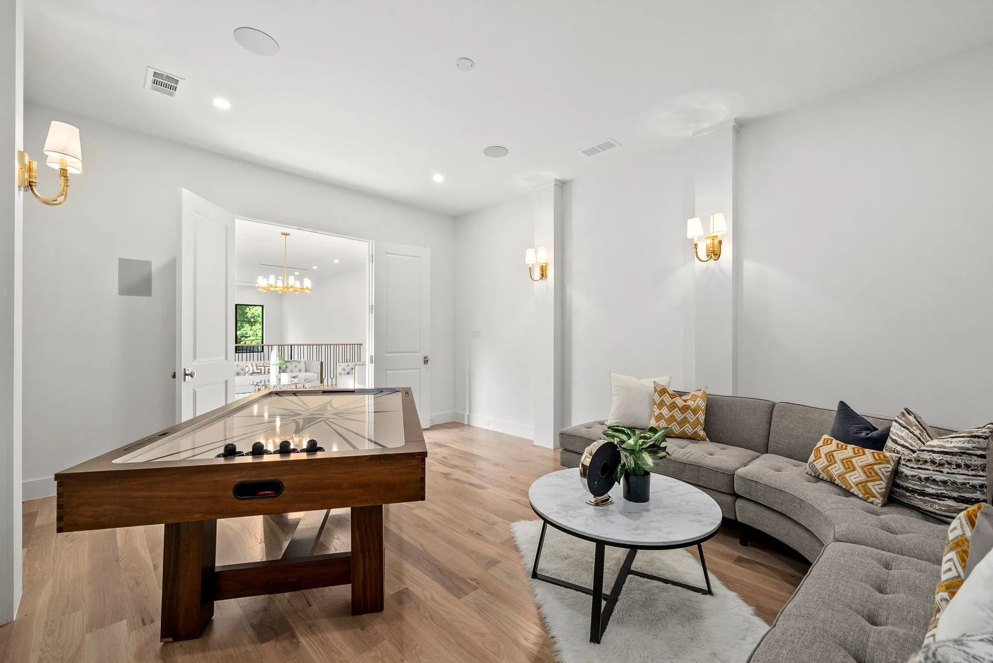 White walls and light wood-finish flooring define this bright room