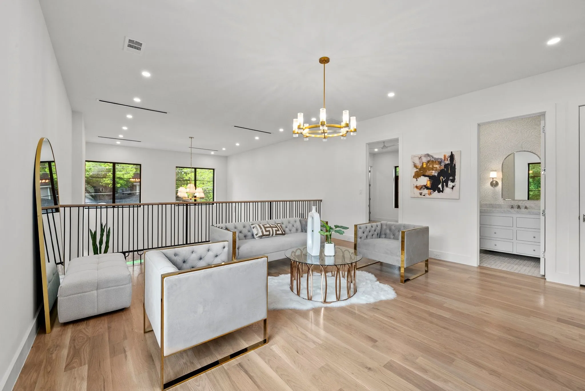 Open concept loft area featuring wood-finish flooring, a contemporary gold chandelier, and recessed lighting
