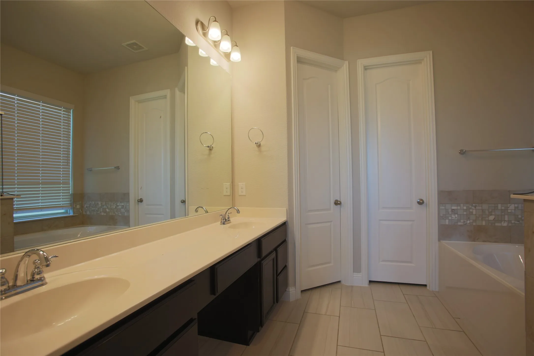 Dual sink vanity with light-toned countertops