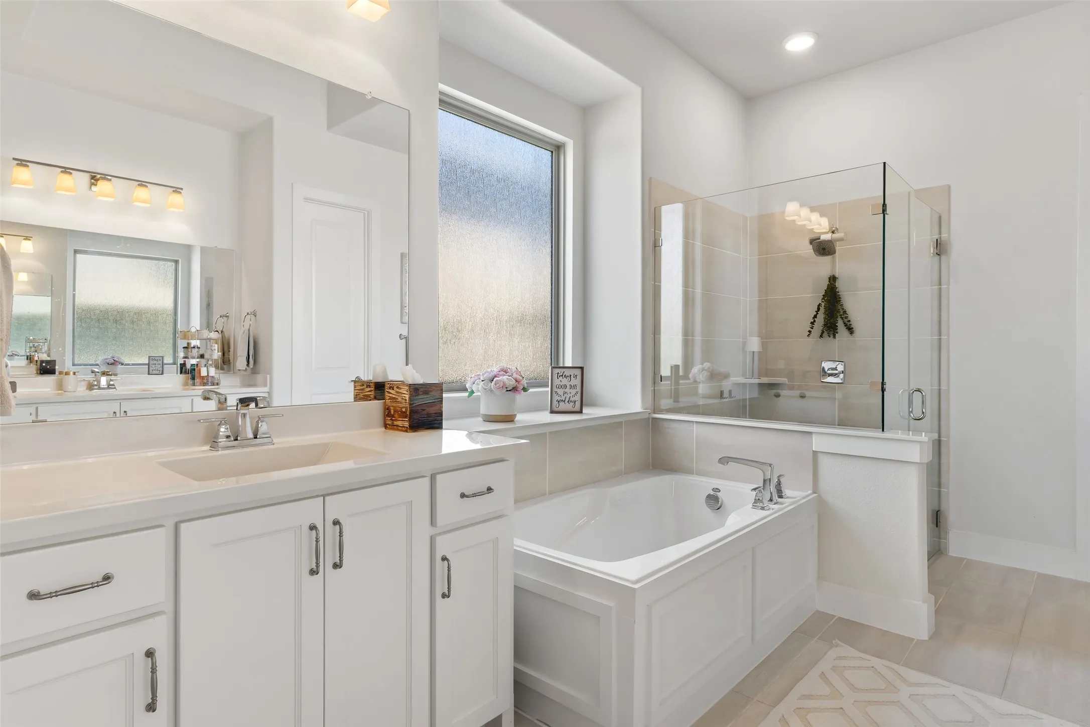 Primary Bath with split vanities and frameless shower