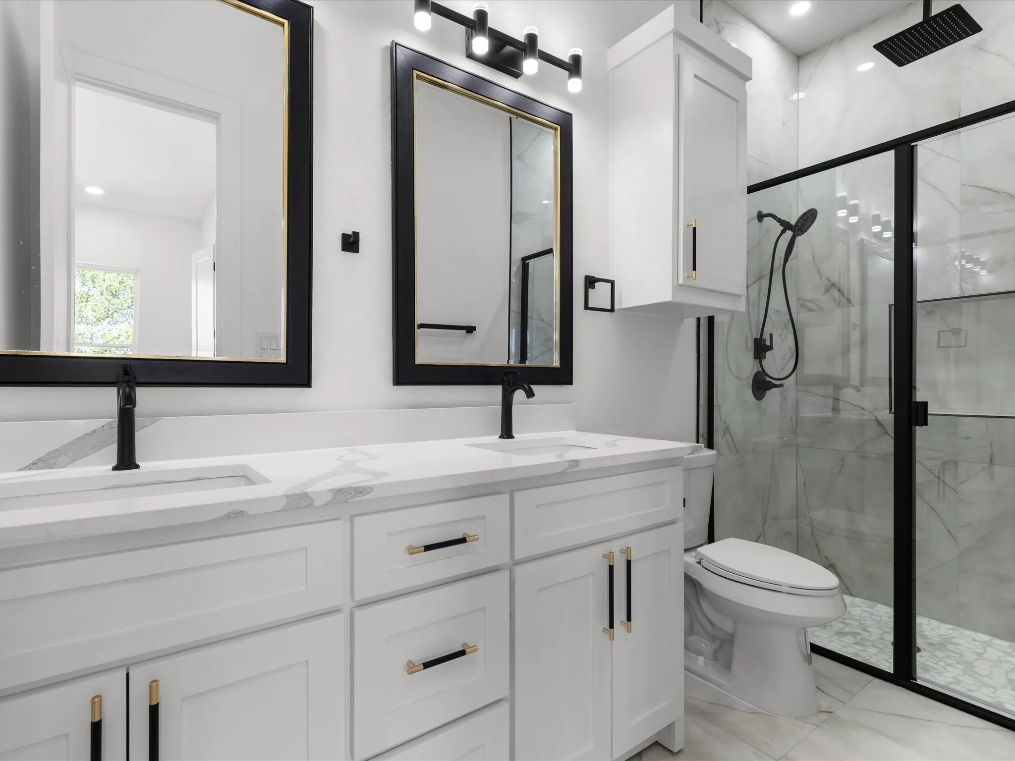 Dual vanity with white cabinetry and integrated sinks, complemented by matte black hardware and faucets