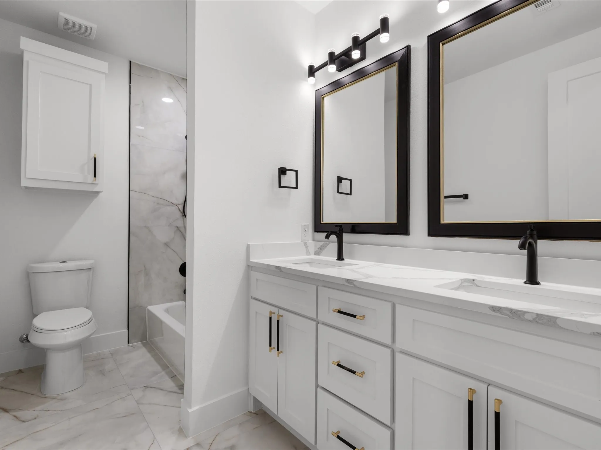 Dual vanity with integrated sinks, white cabinetry, and matte black fixtures