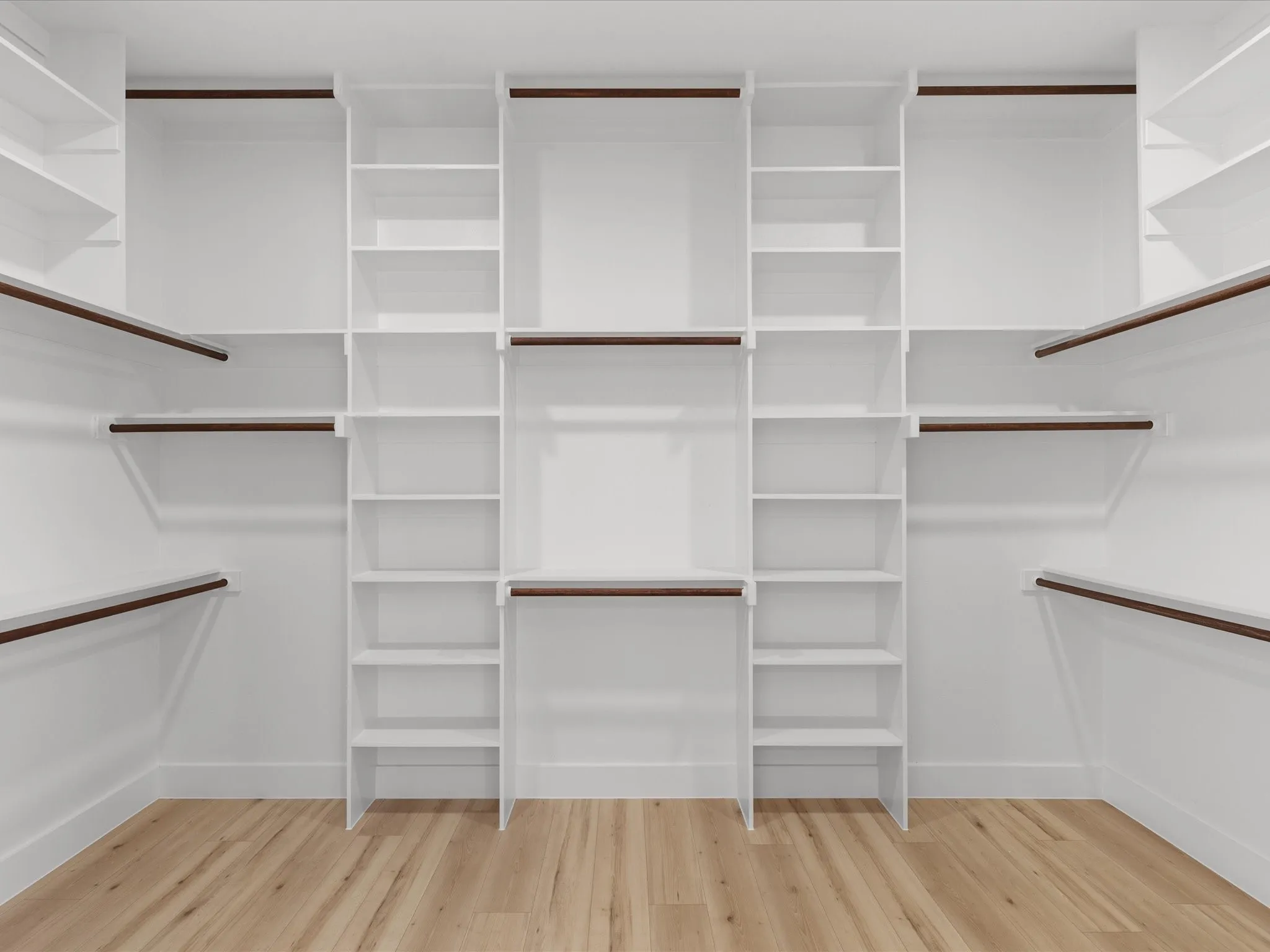 Custom white shelving system with integrated hanging rods and wood-finish flooring