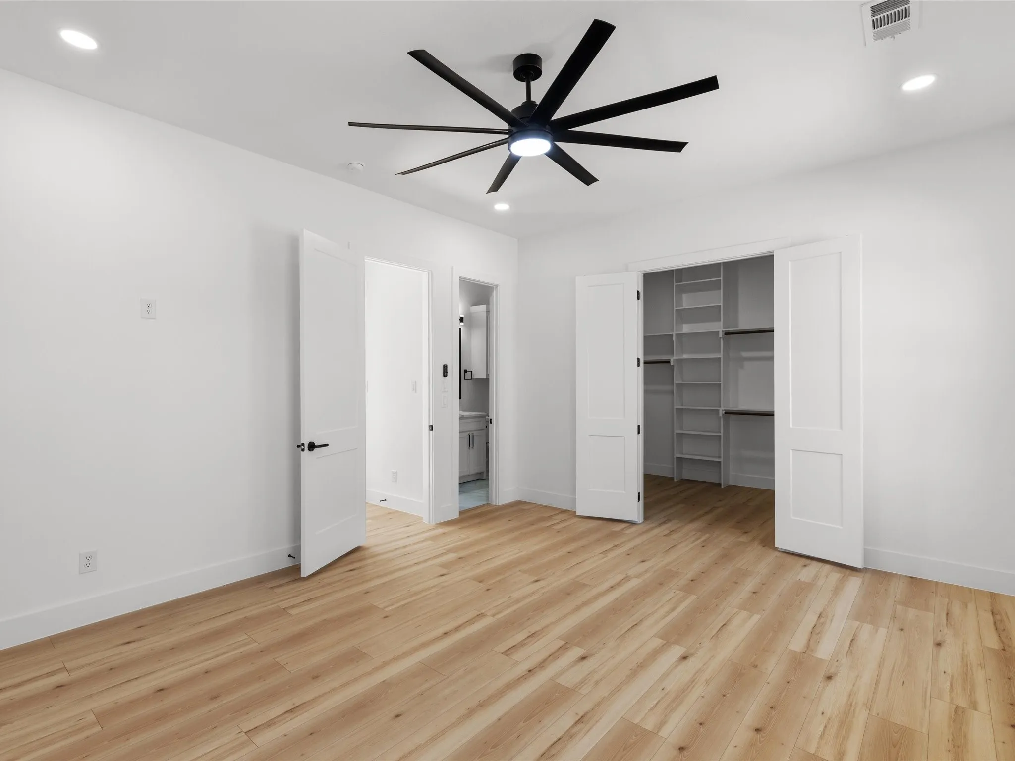 Room featuring wood-finish flooring, recessed lighting, and a modern ceiling fan