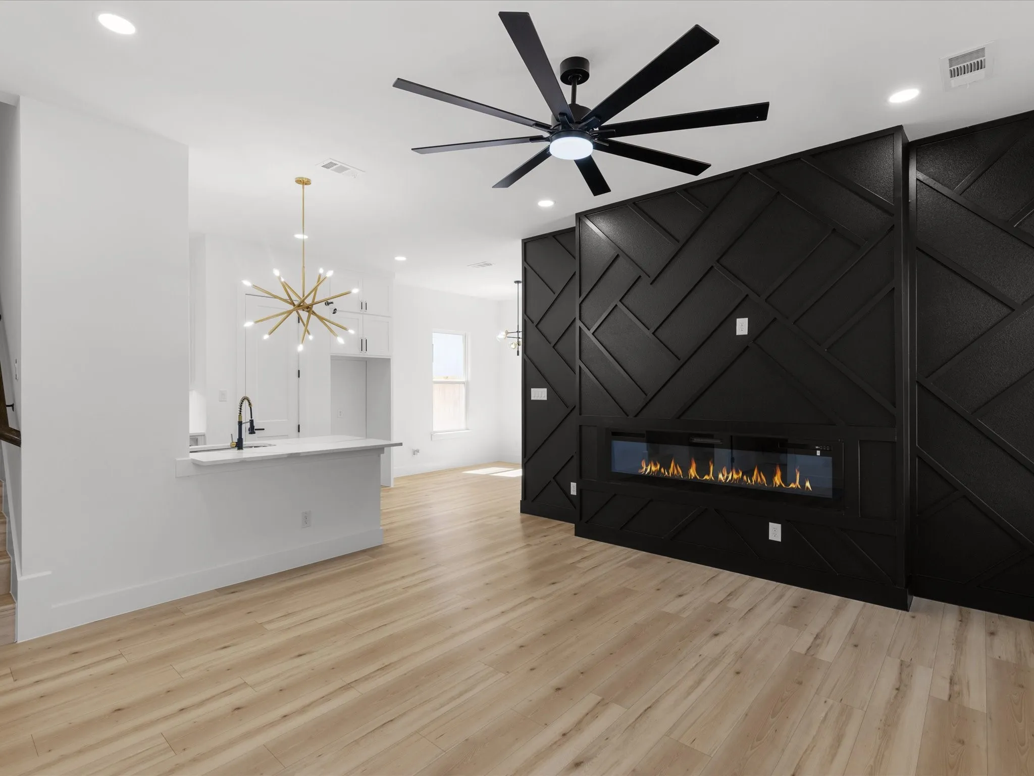 Open-concept living space with light wood-finish flooring