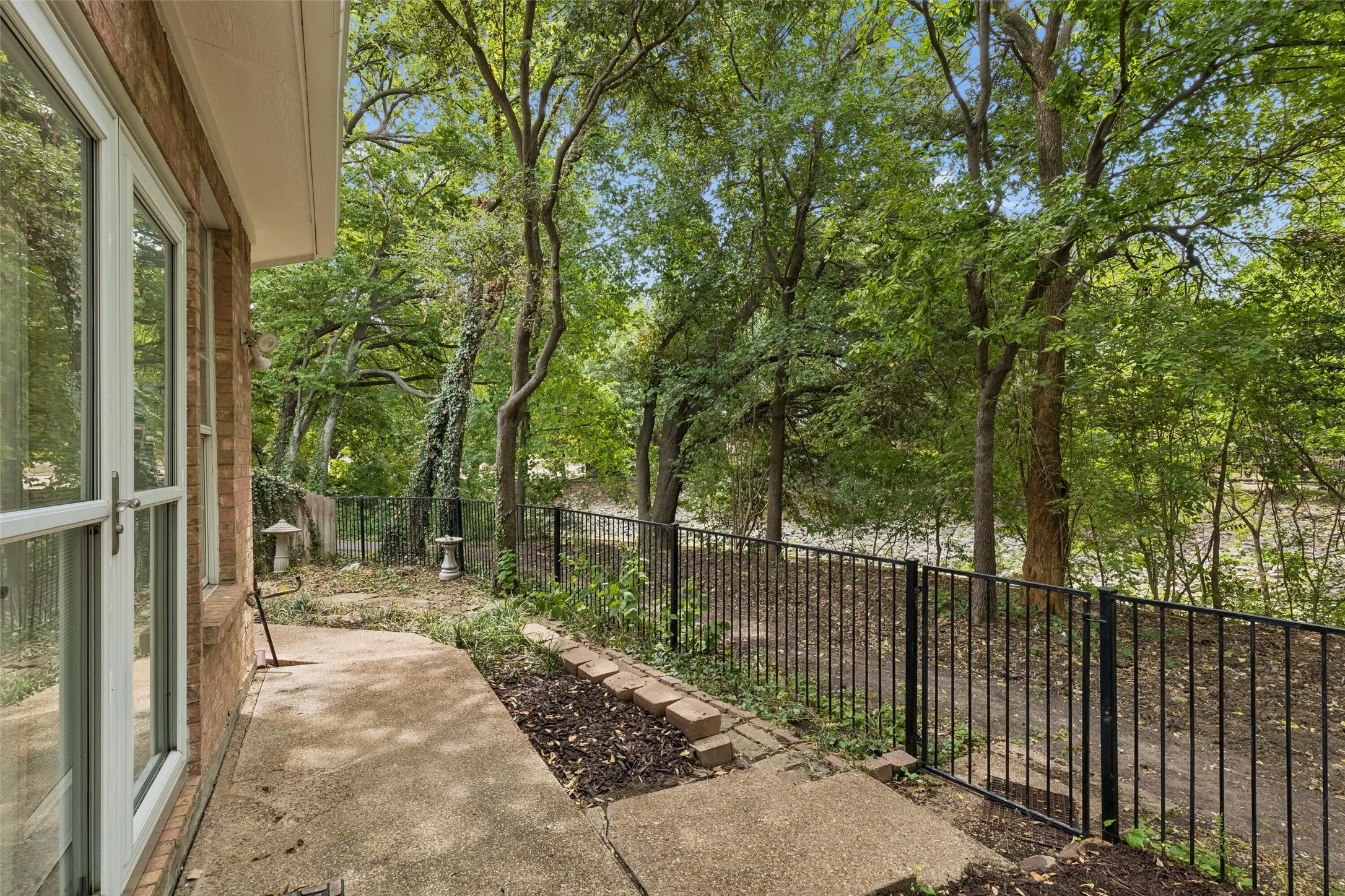 Creek down the ravine. Neighbors on the other side are hidden by trees.