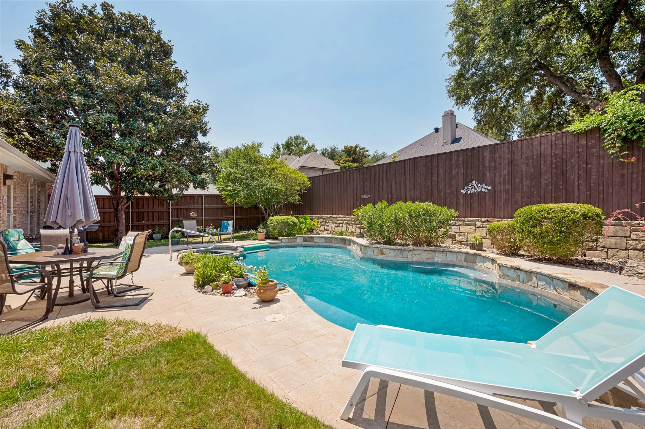 Mature and low maintenance landscaping around the pool