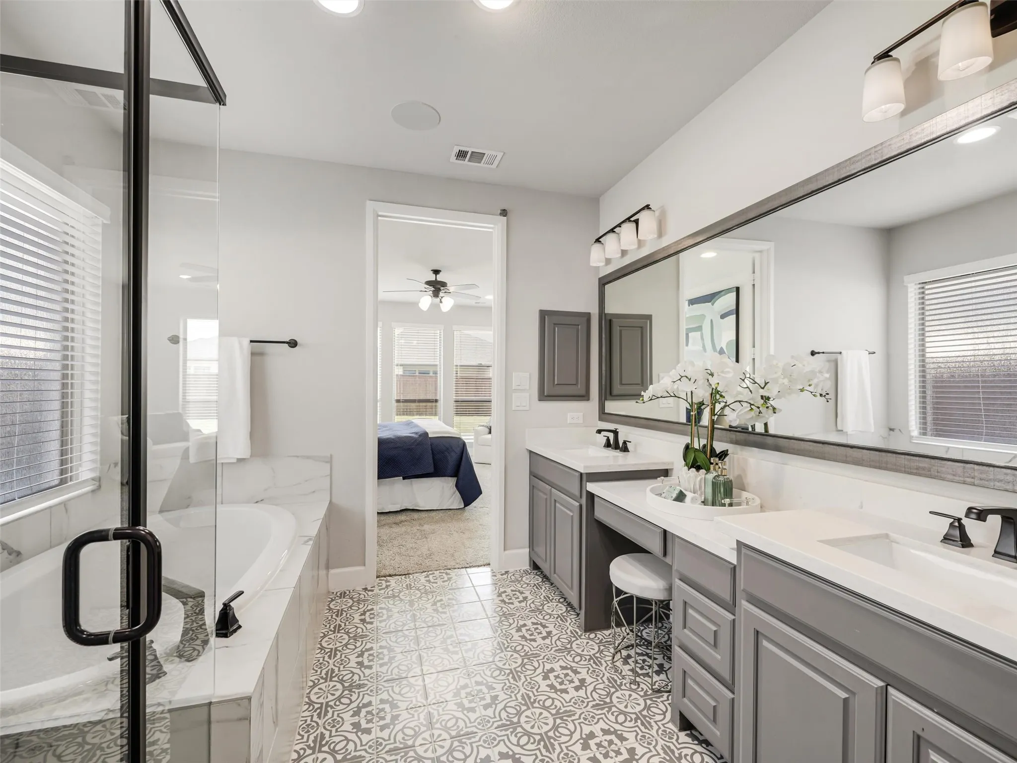 Spacious primary ensuite bath with
Dual quartz vanities, ample storage, and seated makeup vanity