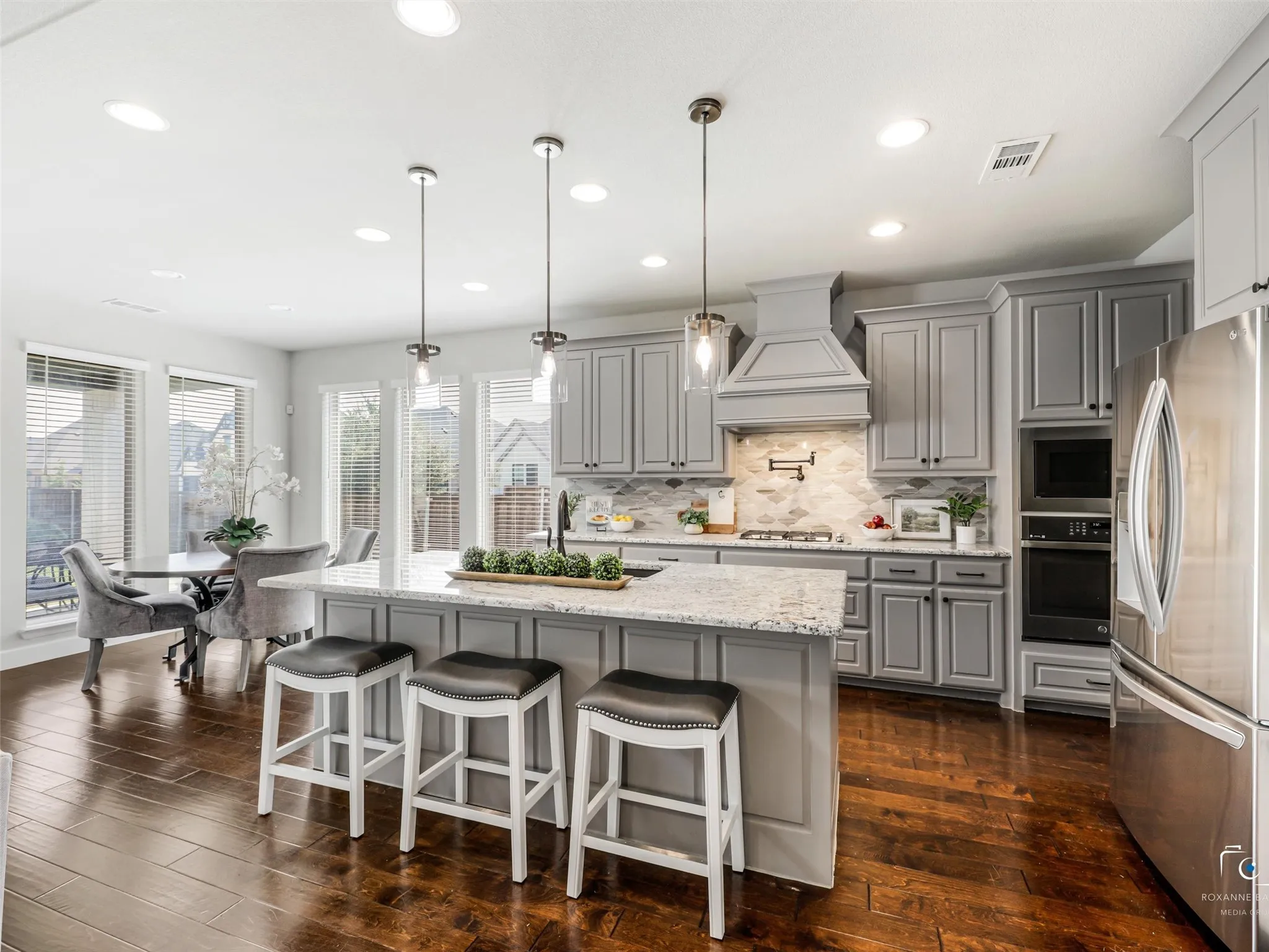 Kitchen upgrades abound... gas range, pot siller, upgraded cabinets, vent hood, backspash & lighting