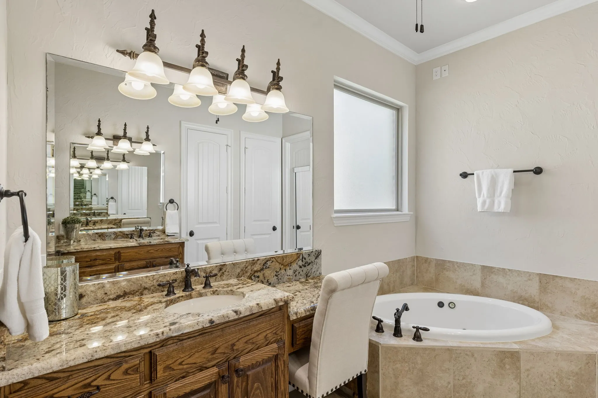 Spacious primary bath with separate vanities, garden tub, and big primary closet. Again, with just a few tweaks could be modern and luxurious.