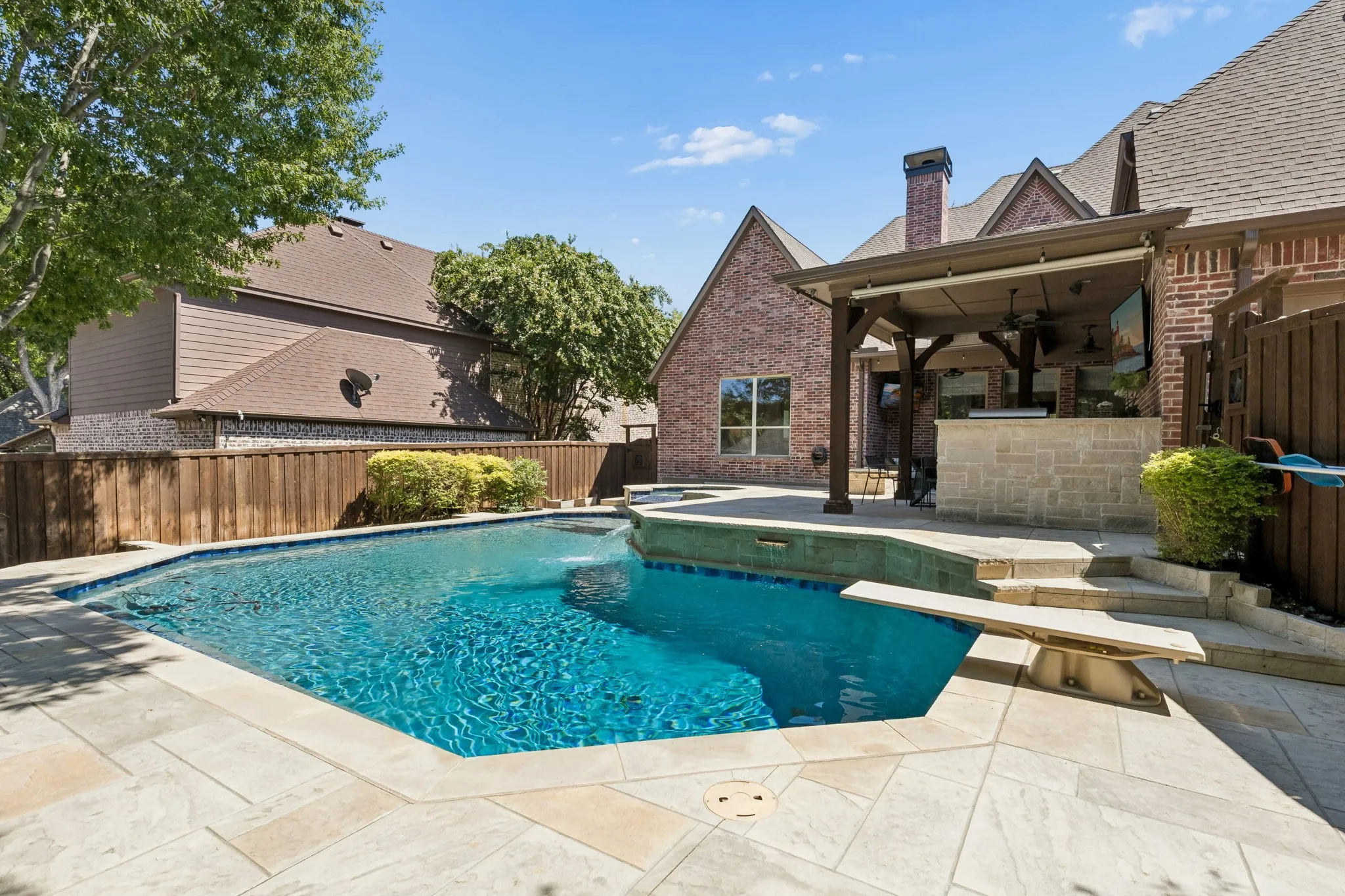 Photos don't do this beautiful pool justice. The decking is beautiful, and the water feature so natural.