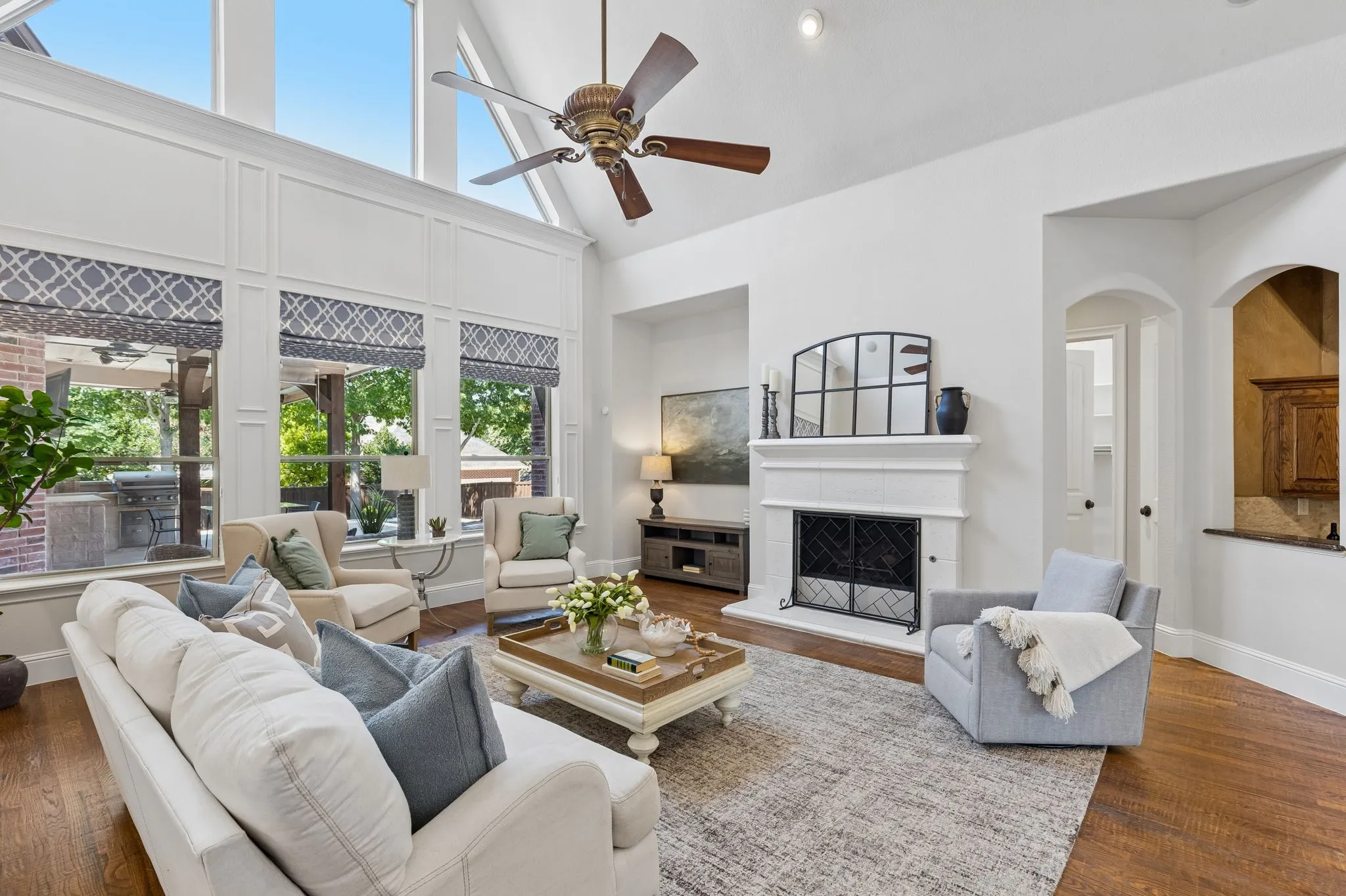 So much to love... the rich hardwood floors and the cast stone fireplace anchoring the room.