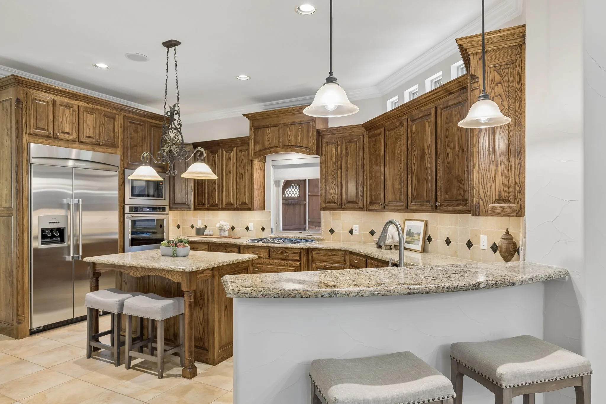 This kitchen is a chef's dream with great prep space, high end appliances, gas cook top, and view to the courtyard.
