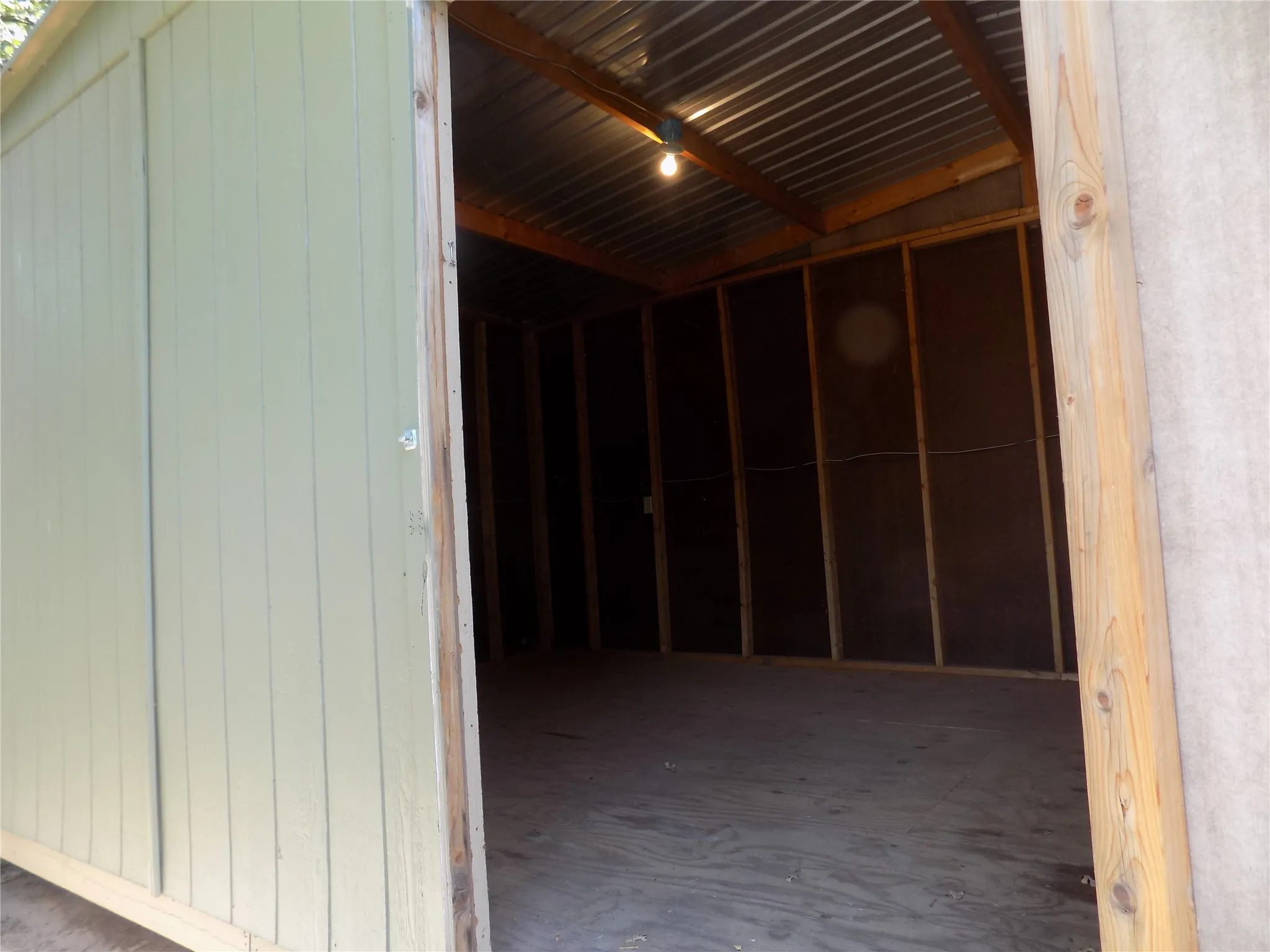 View to the inside of the large 12' x 24' Storage building located in the back yard.