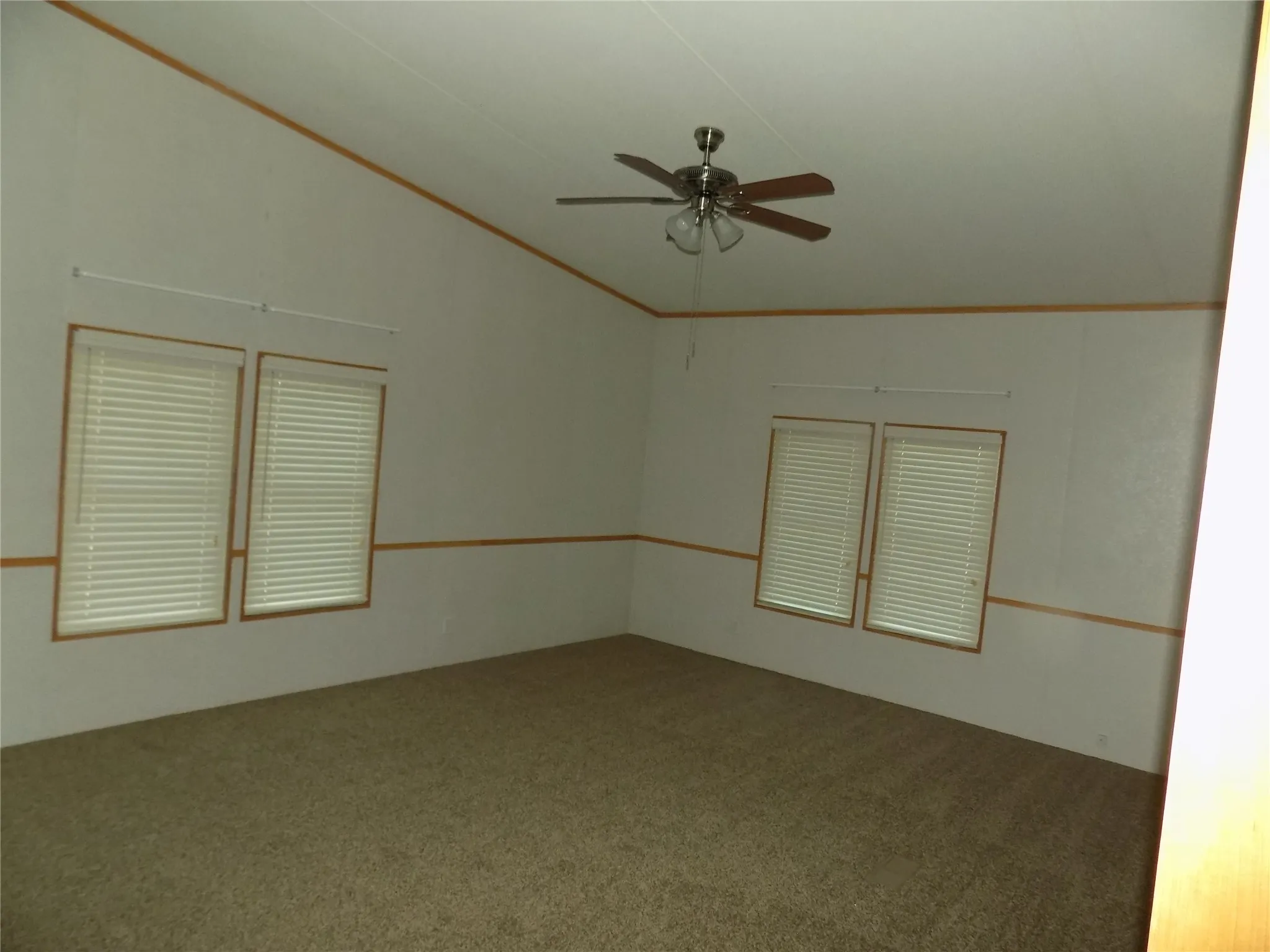 Another view of large, spacious den with wonderful windows, ceiling fans with lights.