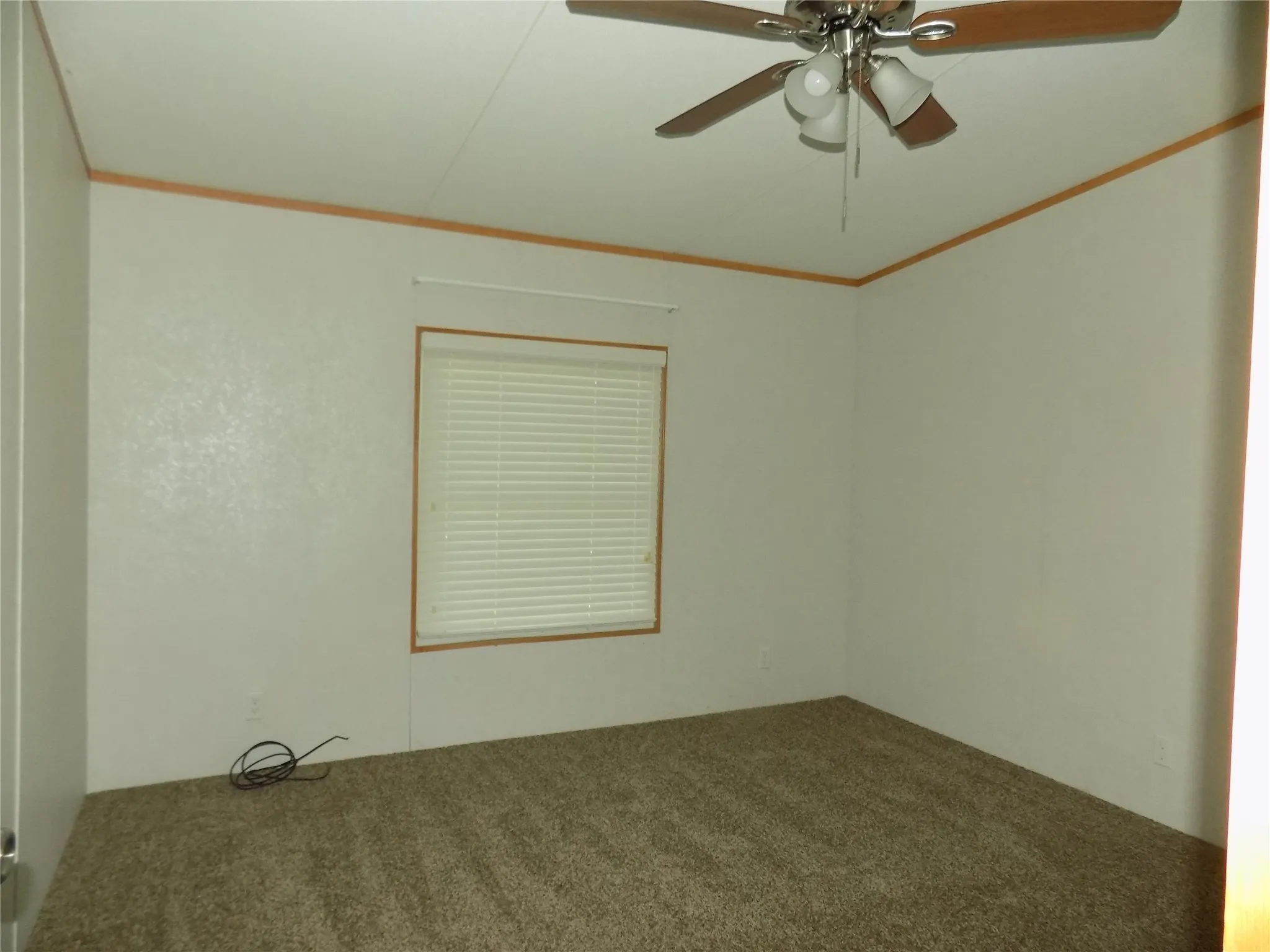 The first bedroom of the secondary bedrooms with ceiling fan with lights.