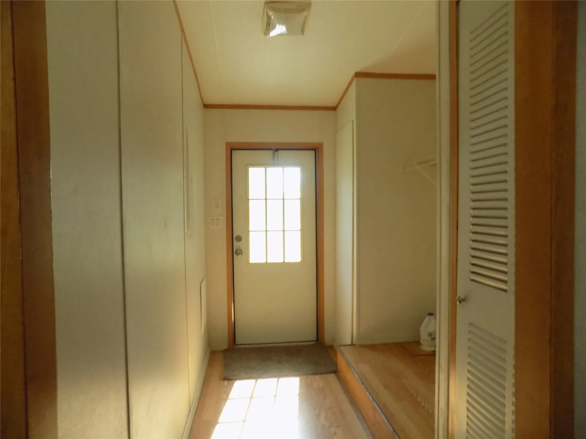 Back door located in large laundry room.