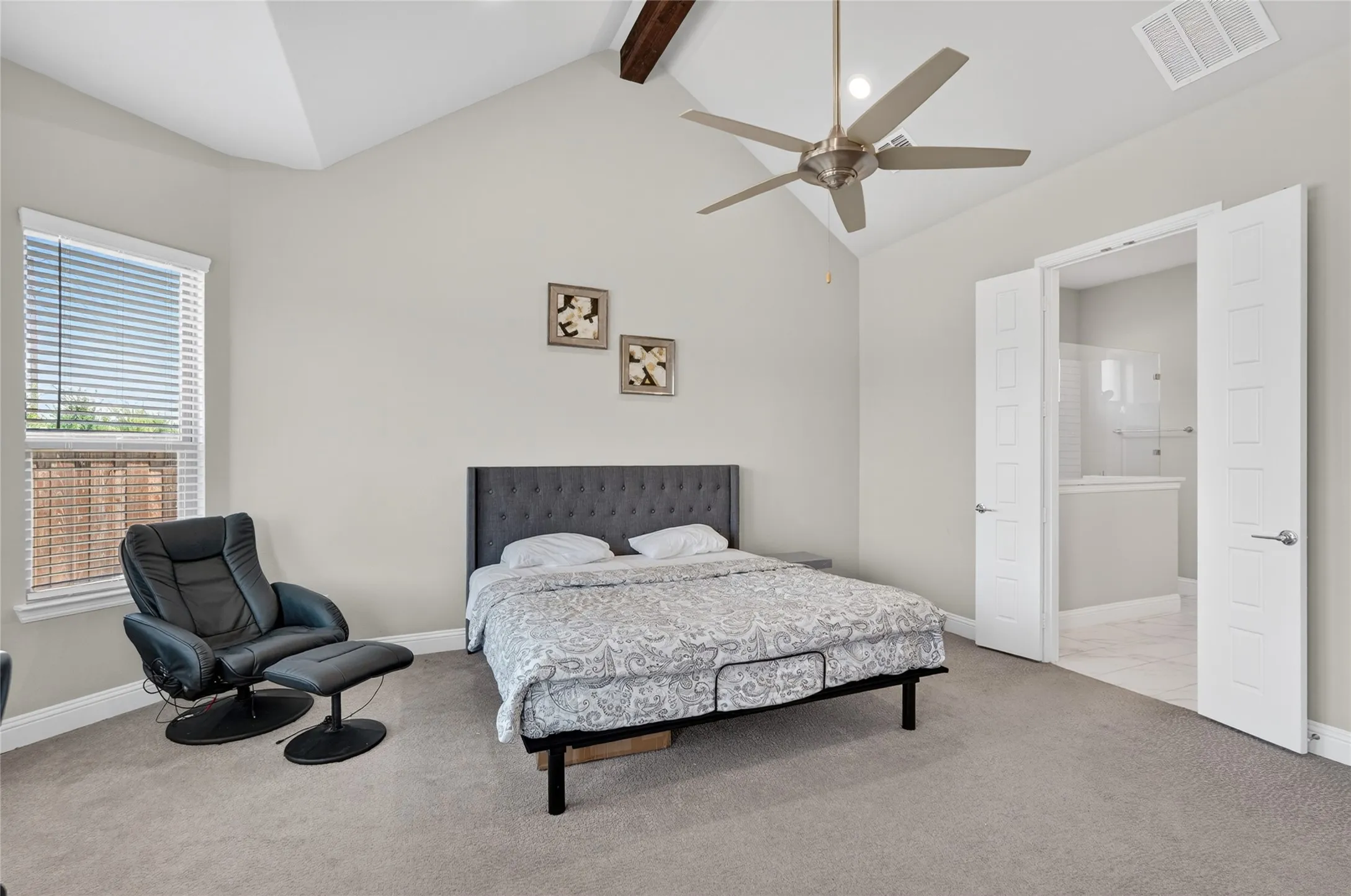 Vaulted ceiling with exposed wood beam and ceiling fan